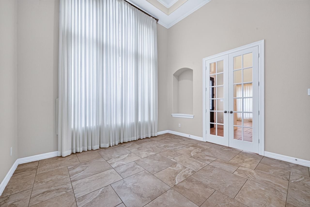 Office with French doors & soaring ceiling by front door
