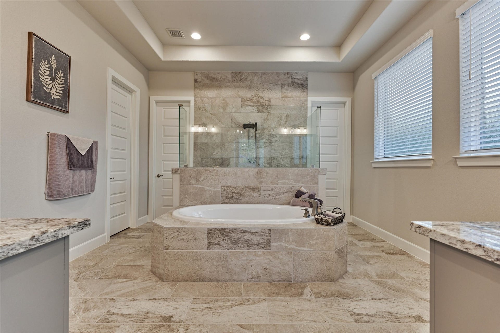 305 Pewter Sky Drive, Montgomery, TX 77316 Spa-like primary bath featuring a deep soaking tub, oversized walk-in shower with frameless glass, floor-to-ceiling tile, dual vanities and abundant natural lightyour own private retreat at the end of the day.