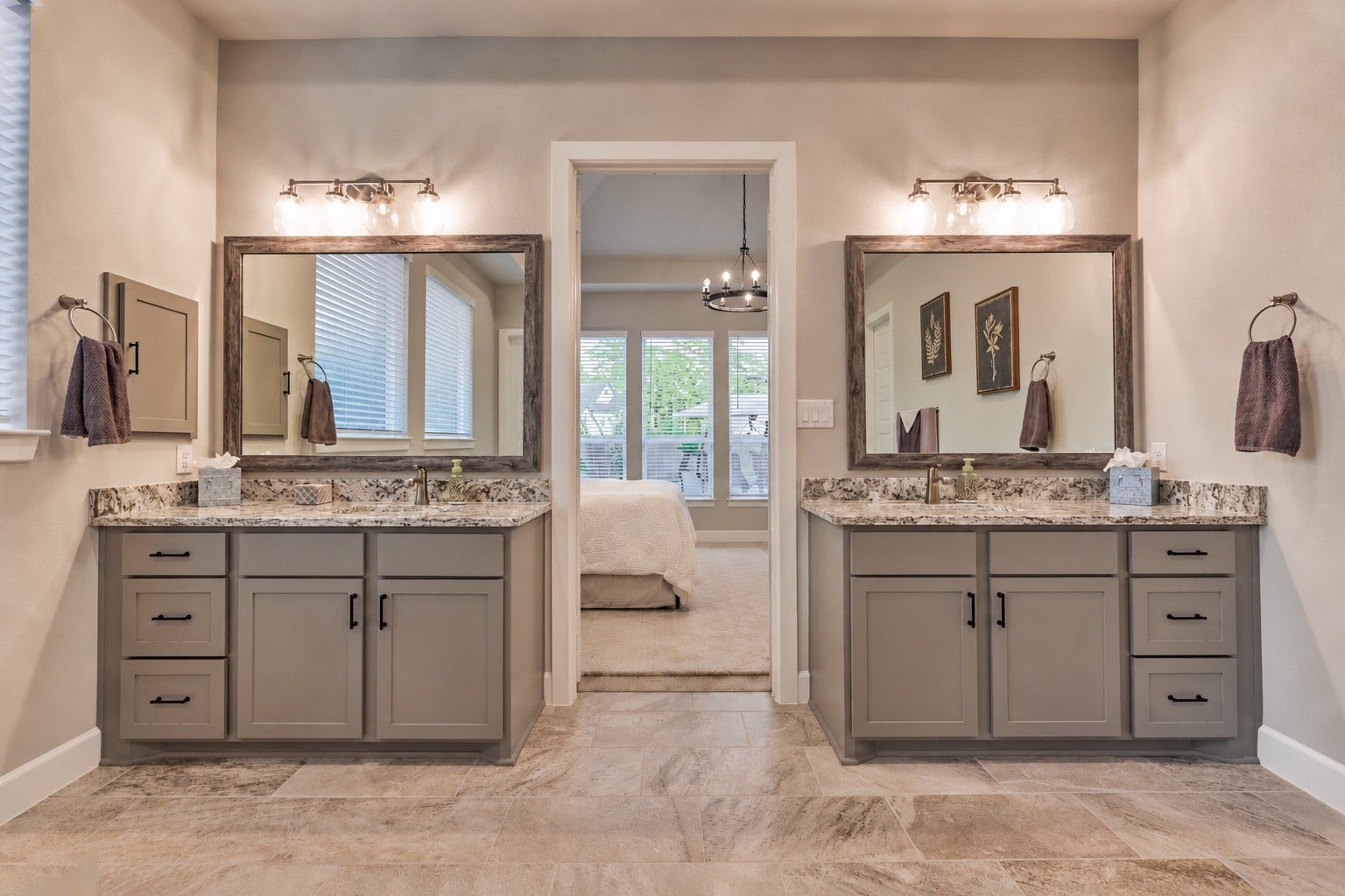 305 Pewter Sky Drive, Montgomery, TX 77316 The spa-inspired primary bath features separate granite-topped vanities with abundant storage, oversized framed mirrors and upgraded lighting, creating a beautifully balanced space with plenty of room to get ready.