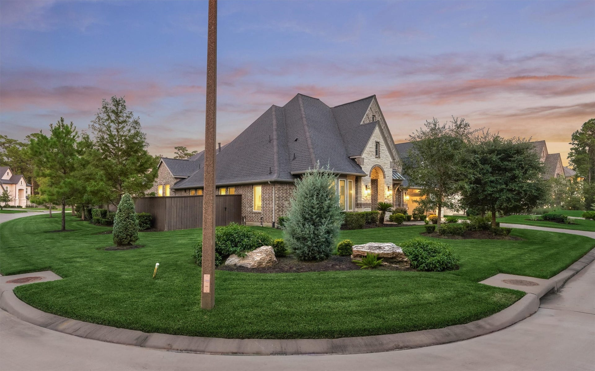 305 Pewter Sky Drive, Montgomery, TX 77316 Beautifully landscaped corner lot featuring mature trees, lush lawn, natural stone accents and impressive curb appeal with added space and privacy.