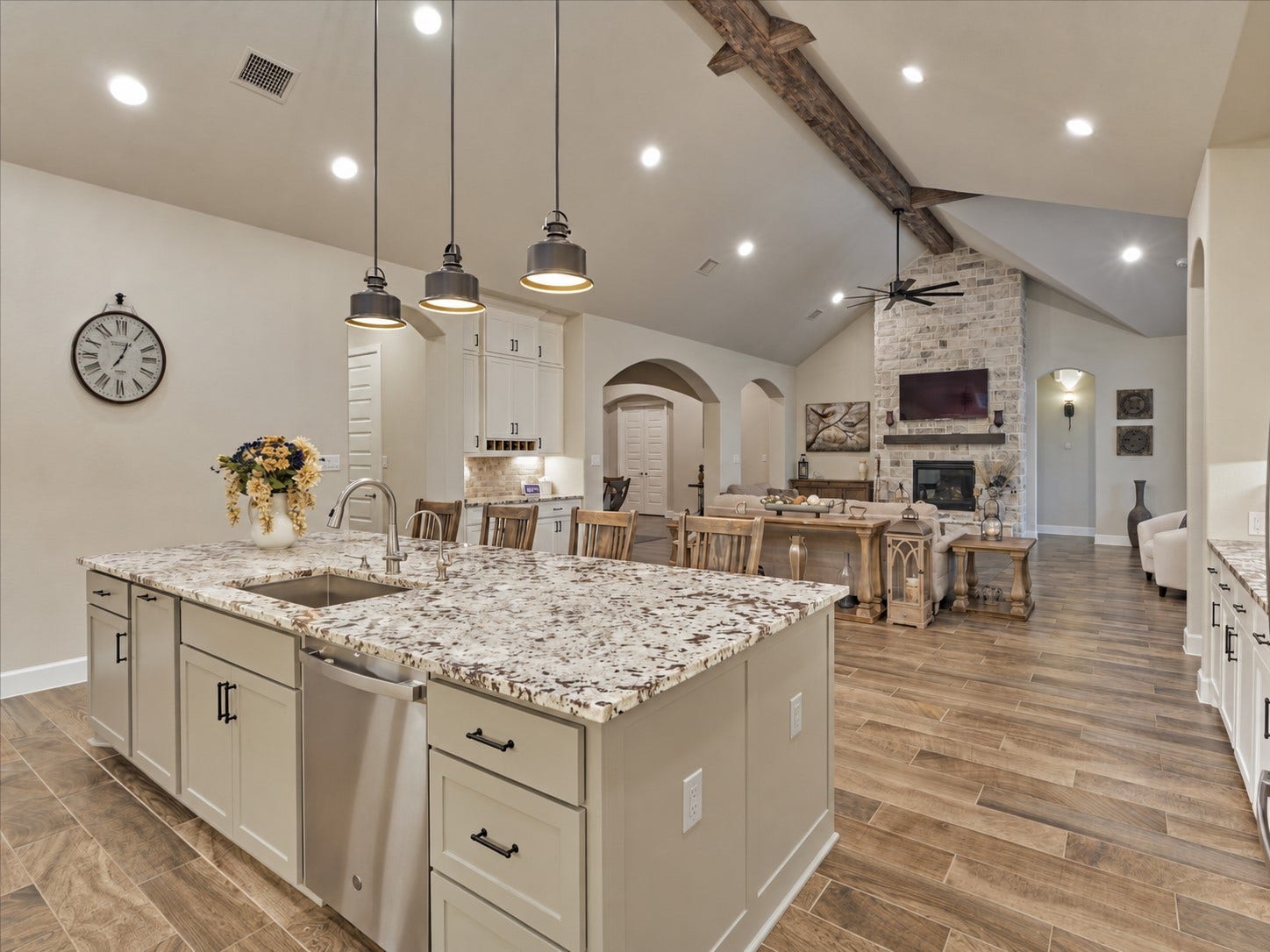 305 Pewter Sky Drive, Montgomery, TX 77316 A true showstopper from every angle! The massive statement island anchors the kitchen while soaring ceilings, dramatic reclaimed wood beams & a direct view of the floor-to-ceiling stone fireplace create an unforgettable wow factor. Open-concept living at its finestgrand, warm, inviting & designed to impress!