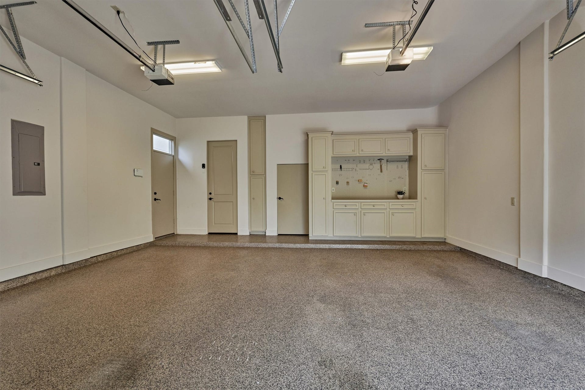 7 Dorset Square, The Woodlands, TX 77381 Two-car garage with epoxy flooring, storage and work bench.