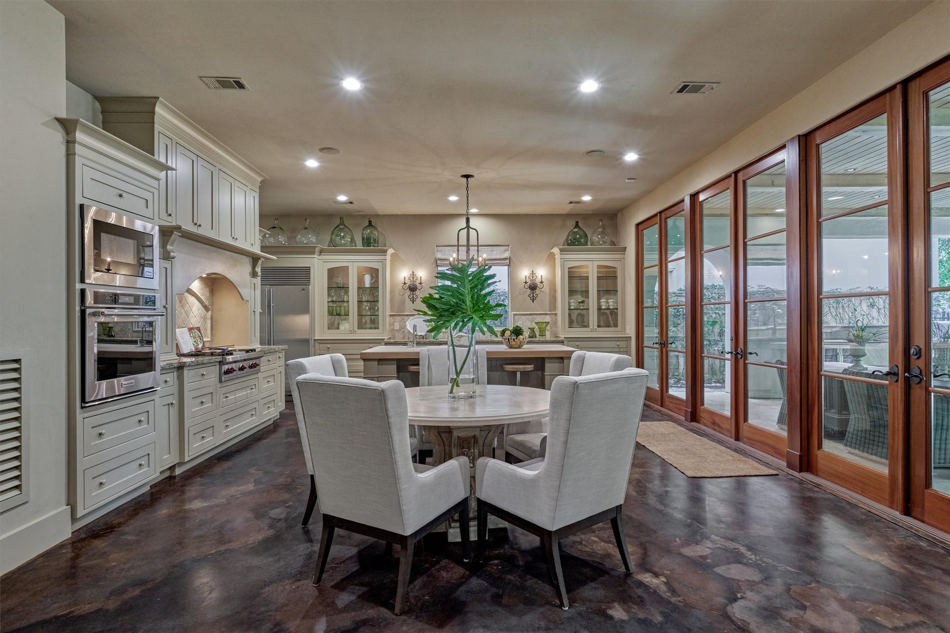 7 Dorset Square, The Woodlands, TX 77381 Breakfast room open to kitchen and breakfast room with a wall of French doors that open & expand living to the outdoor loggia.