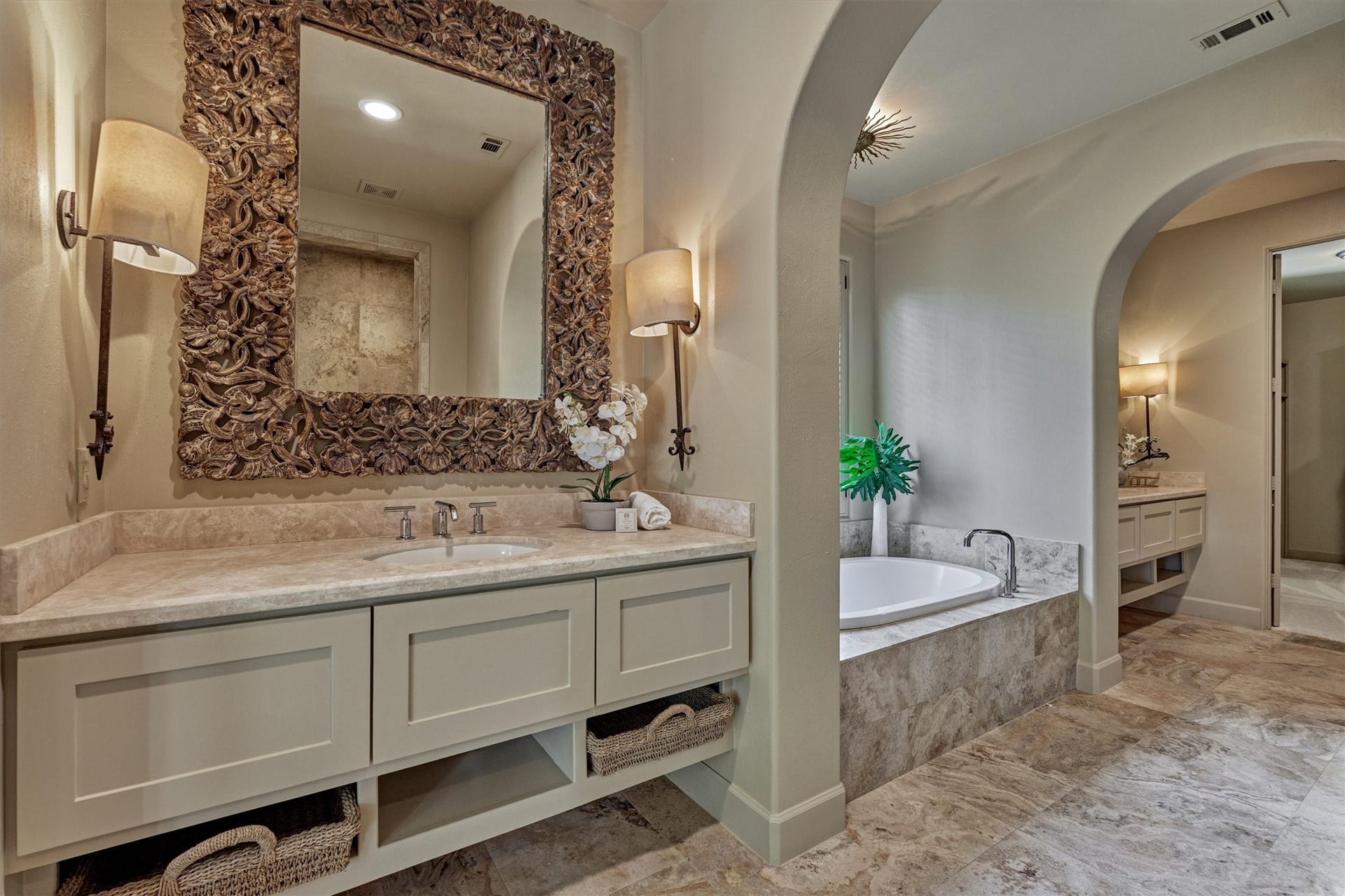 7 Dorset Square, The Woodlands, TX 77381 Primary bath has separate floating vanities, soaking tub, open shelving and sconce lighting.