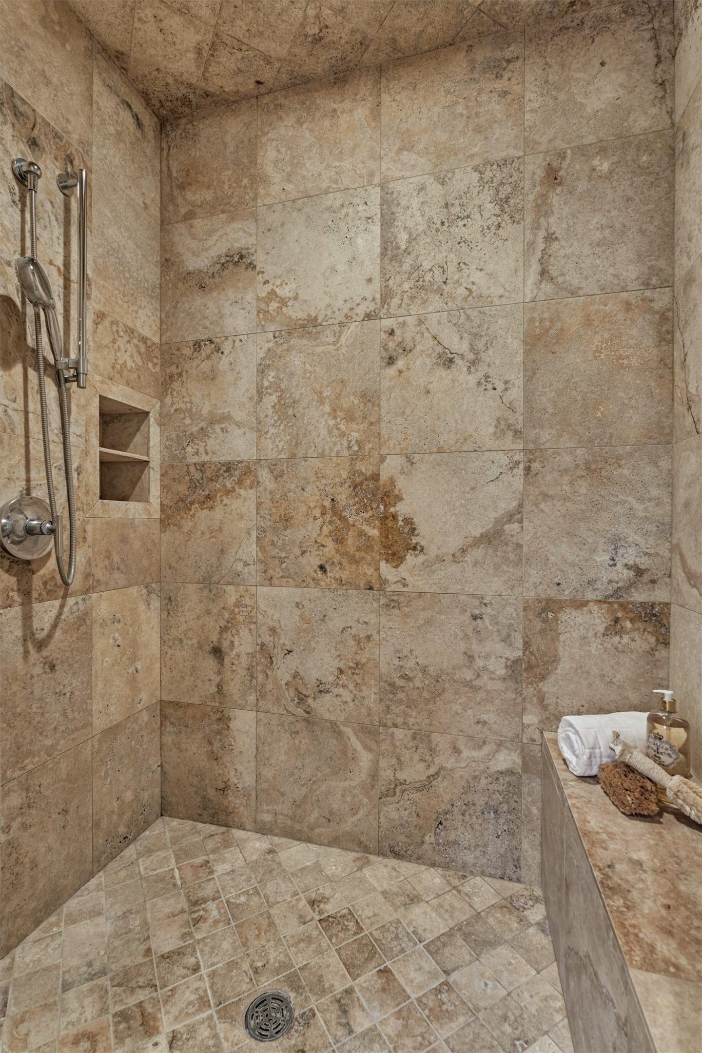 7 Dorset Square, The Woodlands, TX 77381 Spacious walk-in primary shower with built-in bench seating and shelving.