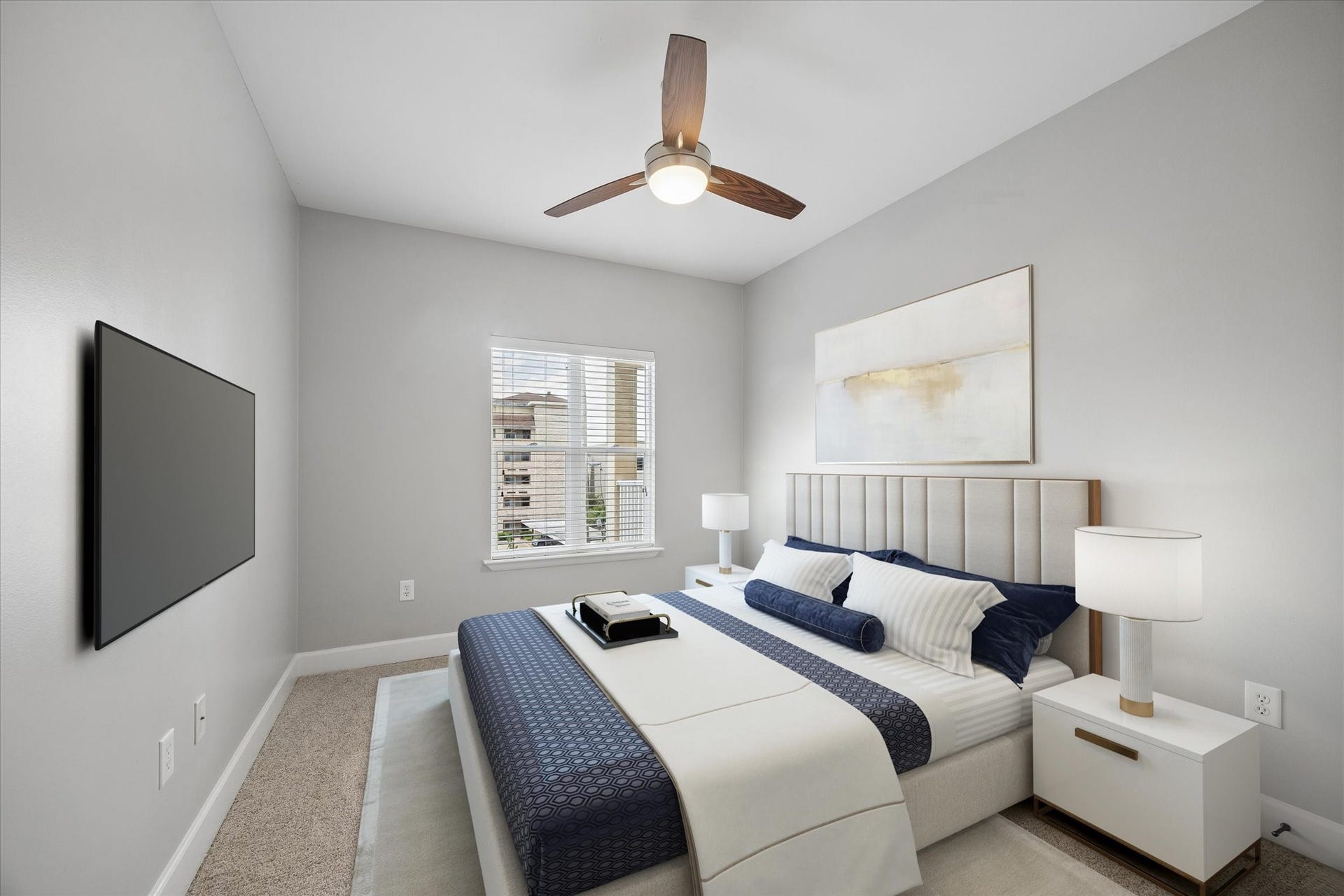 2203 Dorrington Street Street, #205, Houston, TX 77030 This modern bedroom features a cozy design with neutral-toned walls, a recently updated stylish ceiling fan and natural light streaming through a window.