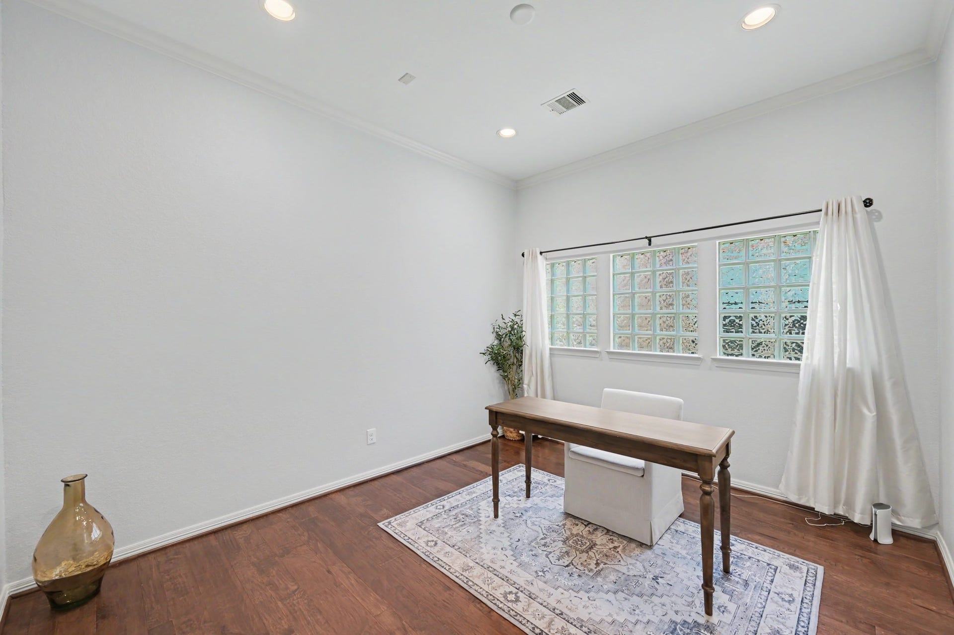 271 Rio Ranch Circle, Montgomery, TX 77316 Bright and inviting home office with elegant wooden flooring, a large window for natural light, and a minimalist design that inspires productivity.