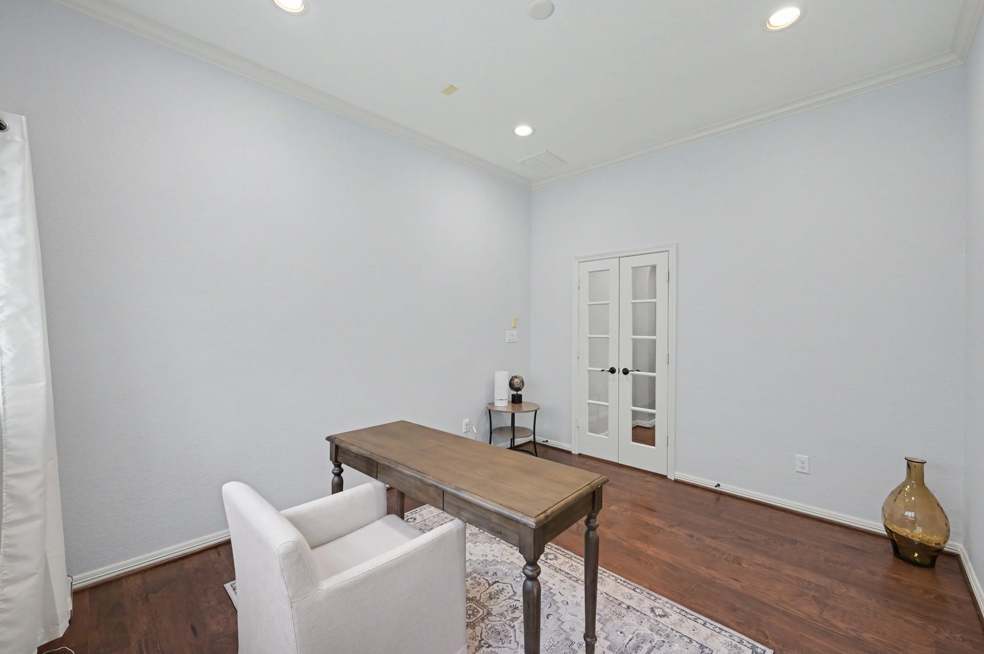 271 Rio Ranch Circle, Montgomery, TX 77316 Bright and inviting home office with elegant French doors, rich hardwood floors, and ample lighting, ideal for productivity and focus.