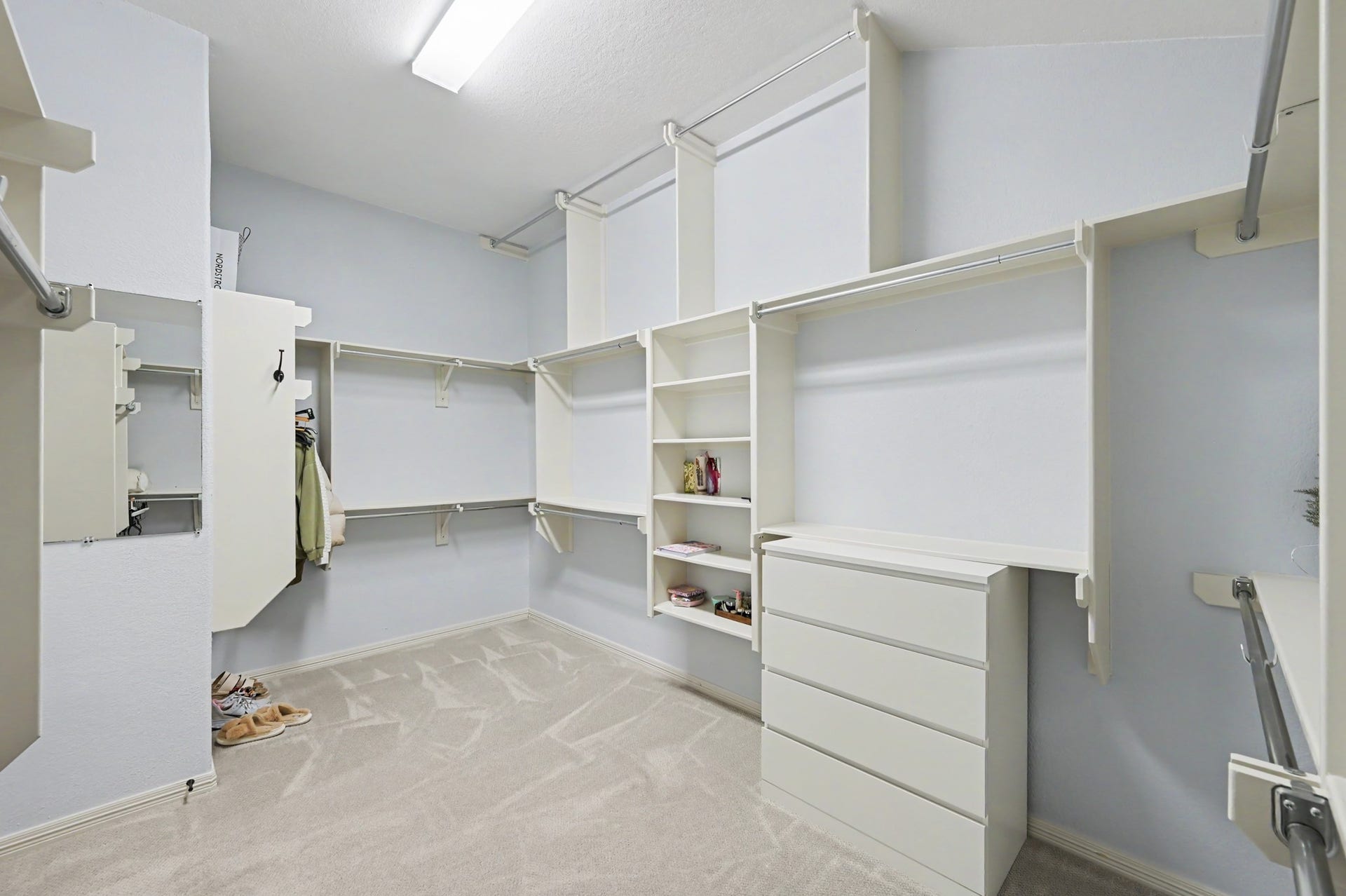 271 Rio Ranch Circle, Montgomery, TX 77316 Spacious walk-in closet featuring custom shelving, ample hanging space, and a built-in dresser for organized storage.