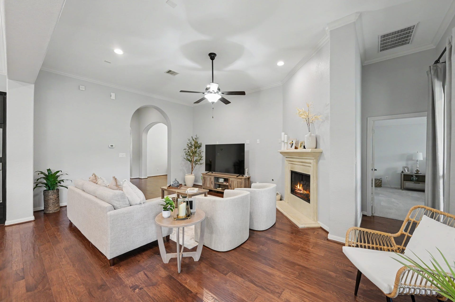 271 Rio Ranch Circle, Montgomery, TX 77316 Spacious living room featuring elegant hardwood floors, a cozy fireplace, and abundant natural light, perfect for relaxation and entertaining.