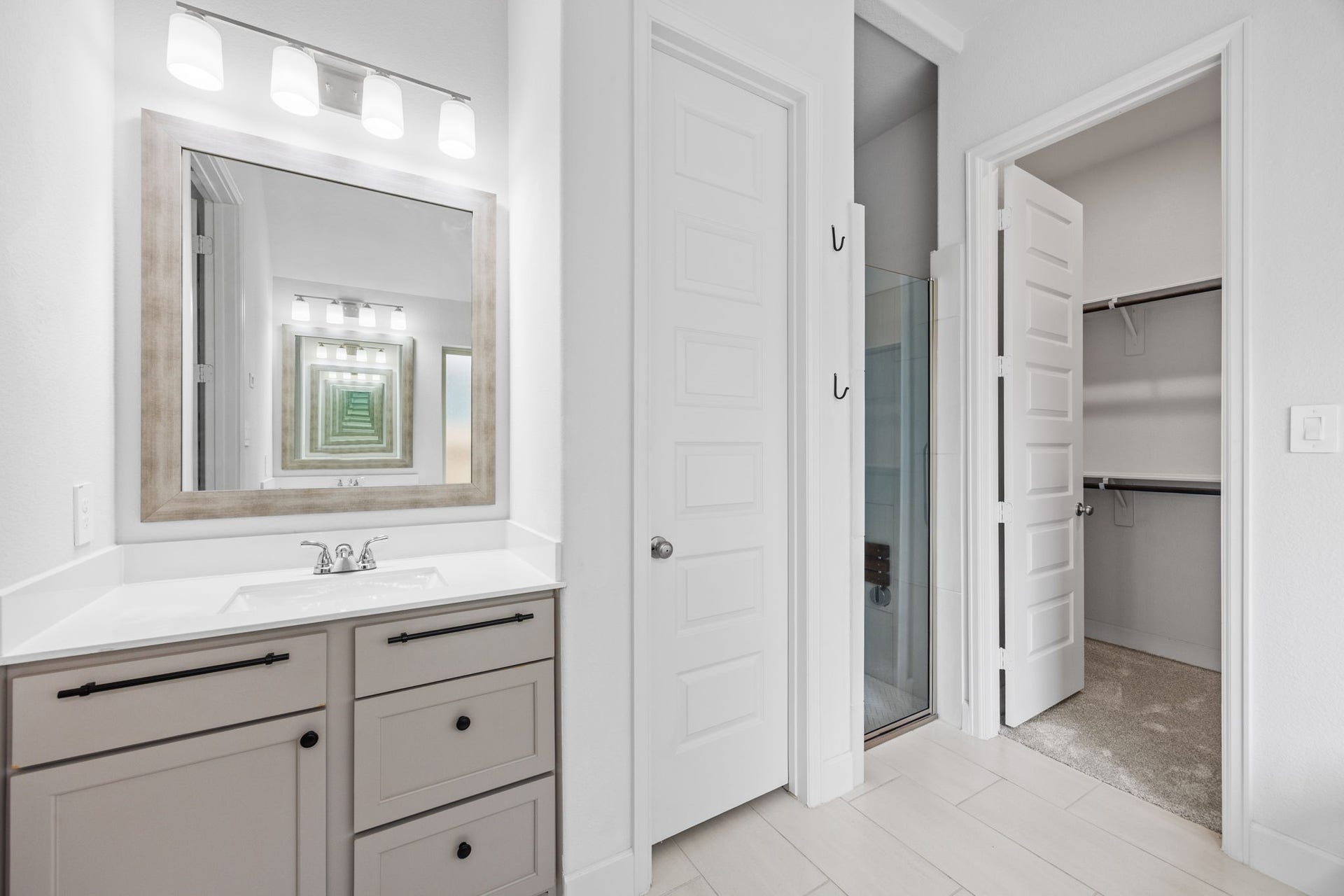 726 Fall Rock Branch Drive, Conroe, TX 77304 Spacious bathroom vanity with generous storage and convenient access to the adjoining walk-in closet.