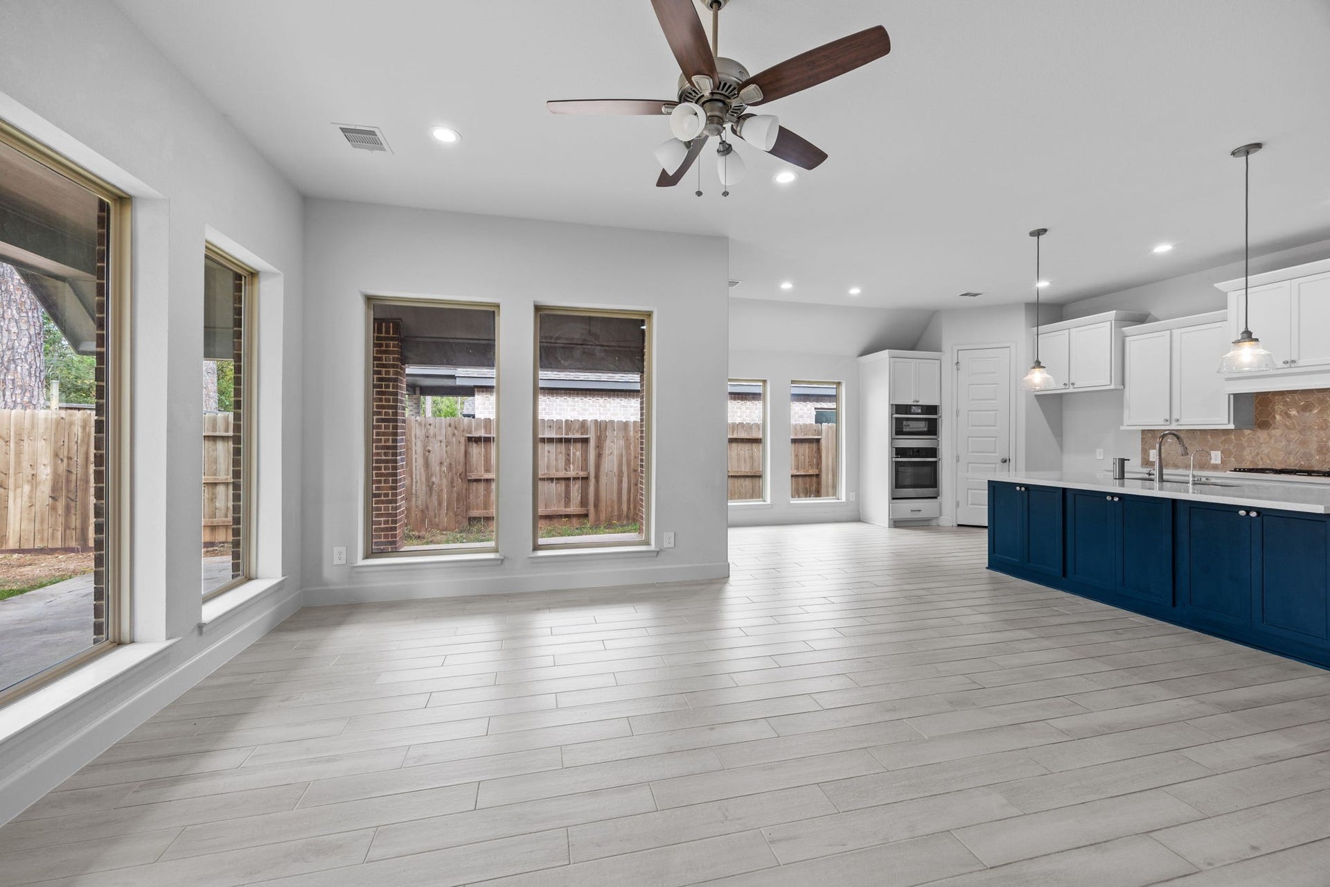 726 Fall Rock Branch Drive, Conroe, TX 77304 Seamless flow between the kitchen, dining, and living spaces creates an inviting atmosphere.
