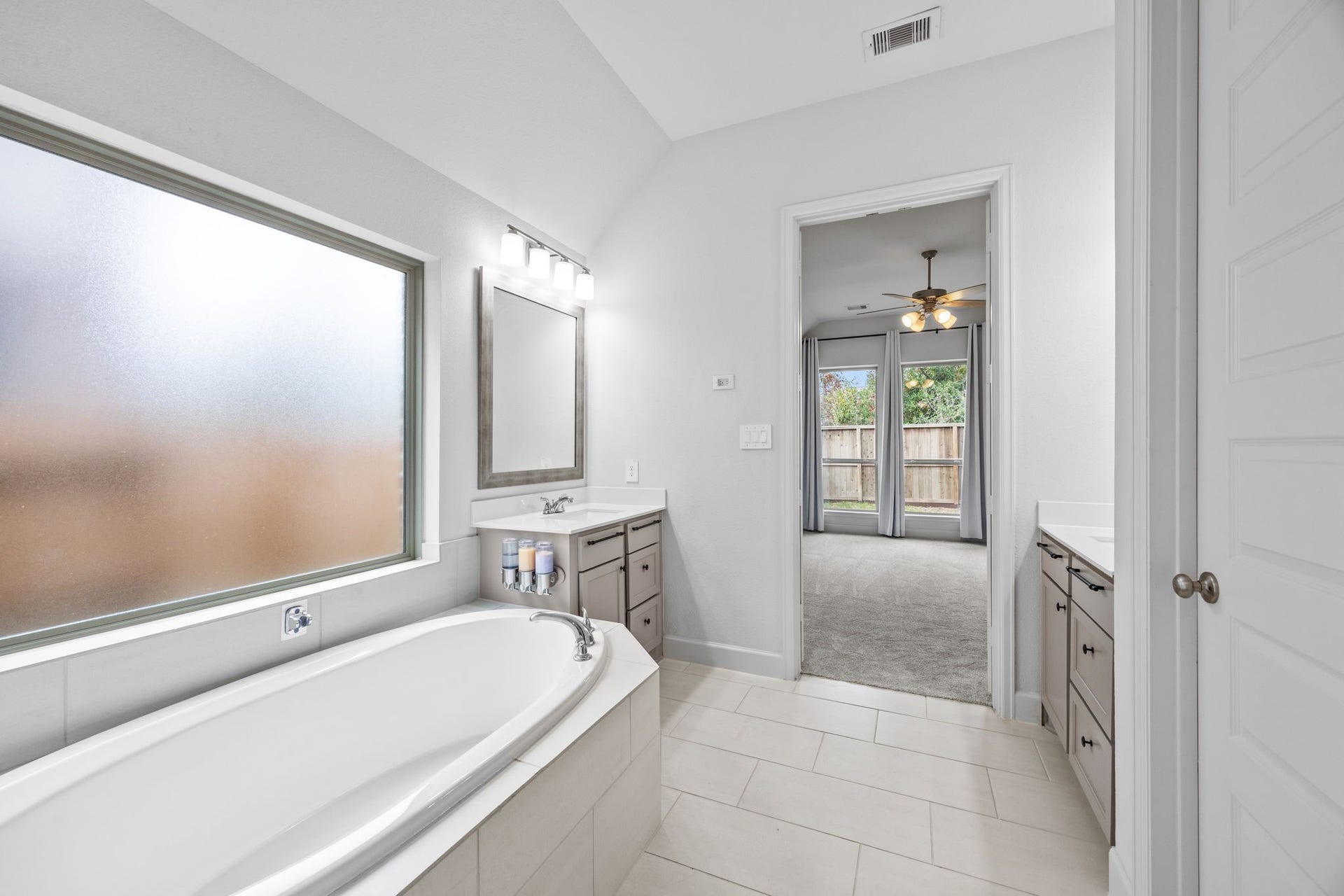 726 Fall Rock Branch Drive, Conroe, TX 77304 Spa-inspired bathroom with a luxurious soaking tub, abundant natural light, and elegant finishes.