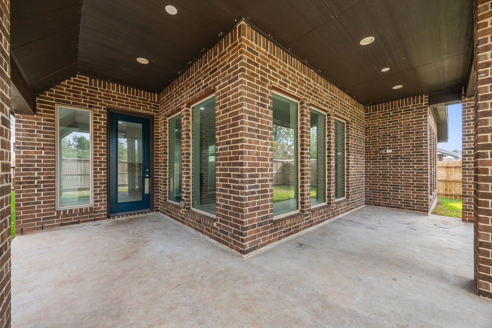 726 Fall Rock Branch Drive, Conroe, TX 77304 Inviting covered patio with a beautifully finished ceiling, recessed lighting, and plenty of space for outdoor entertaining.