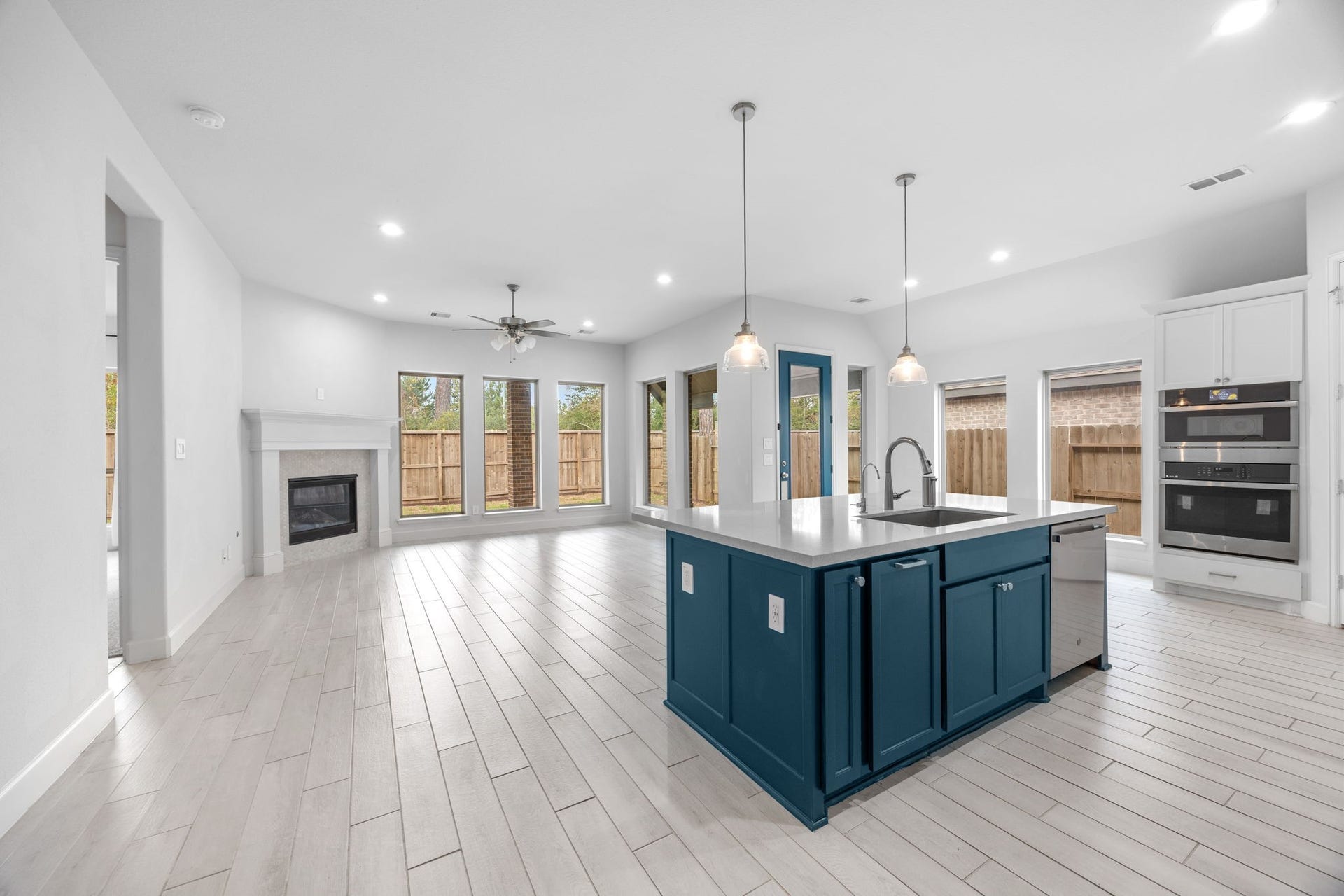726 Fall Rock Branch Drive, Conroe, TX 77304 Spacious chef-inspired kitchen with an oversized island, abundant cabinetry, and stylish pendant lighting.