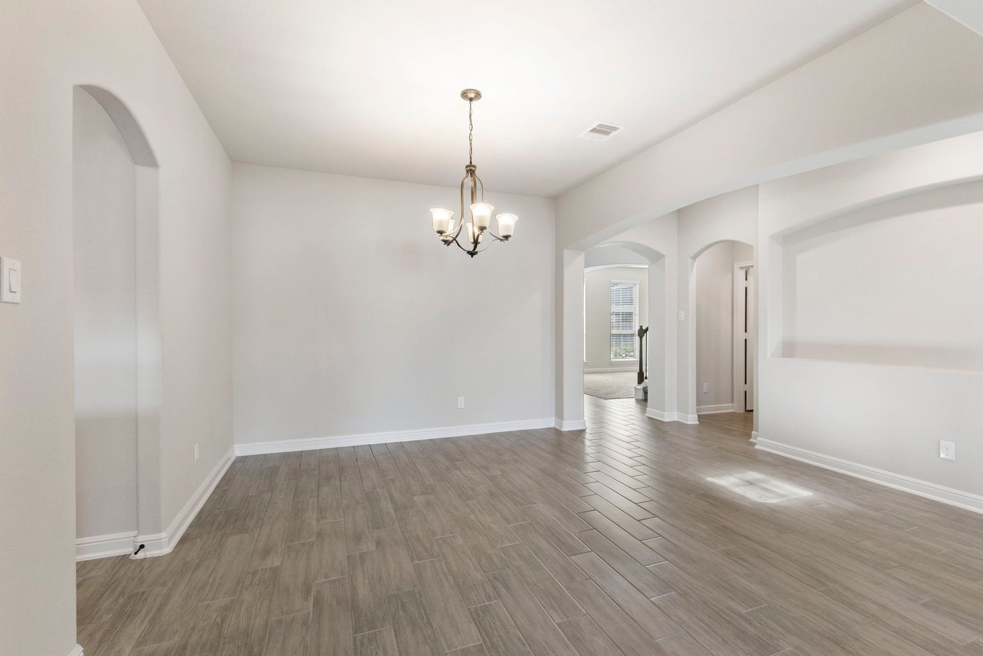 2819 Bradbury Hills Drive, Spring, TX 77373 Experience elegance in this inviting formal dining room, featuring sleek flooring and a sophisticated chandelier, perfect for hosting memorable gatherings.