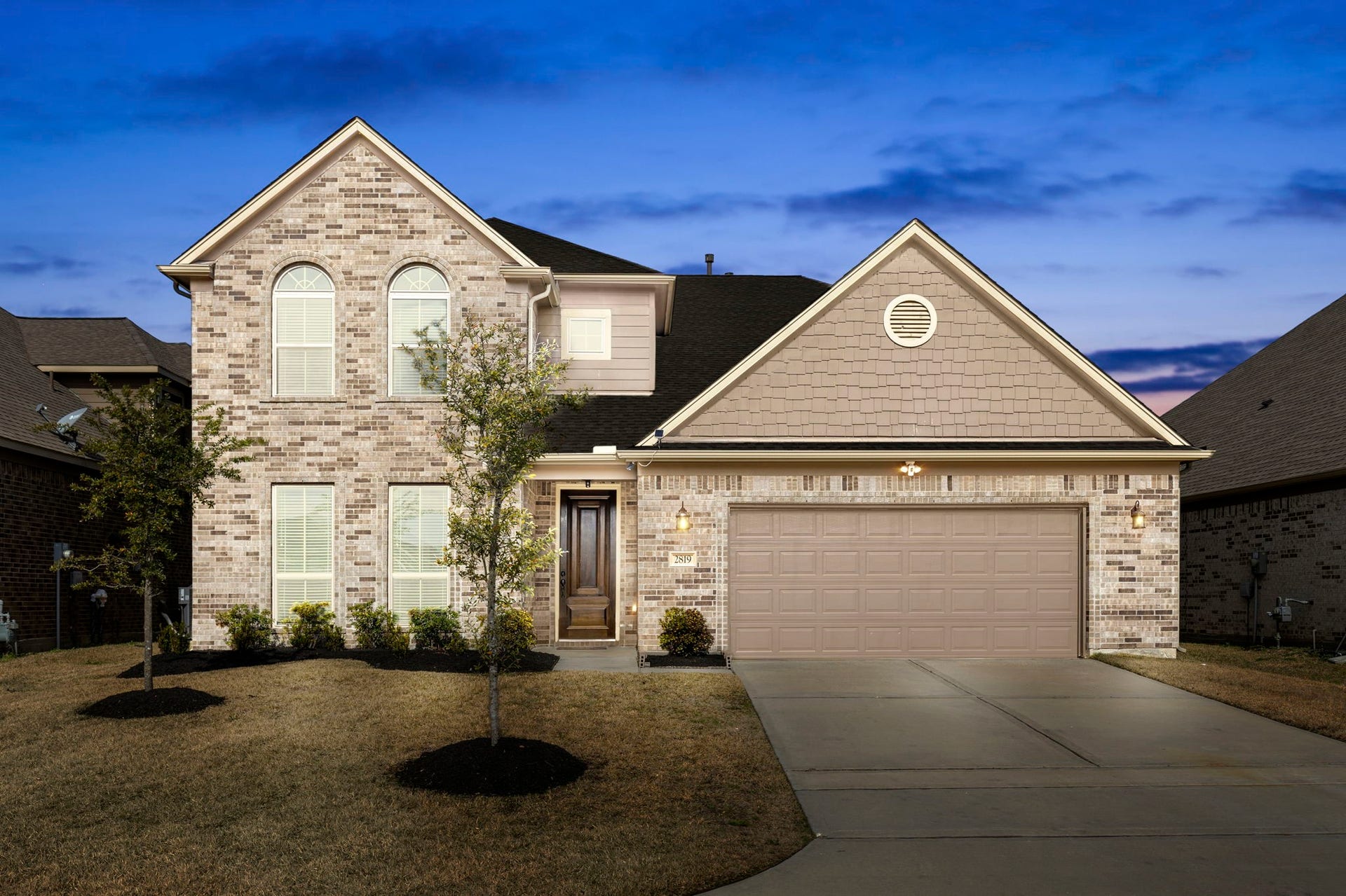 2819 Bradbury Hills Drive, Spring, TX 77373 Experience the charm of this elegant brick home at twilight, featuring a welcoming facade and serene suburban ambiance.