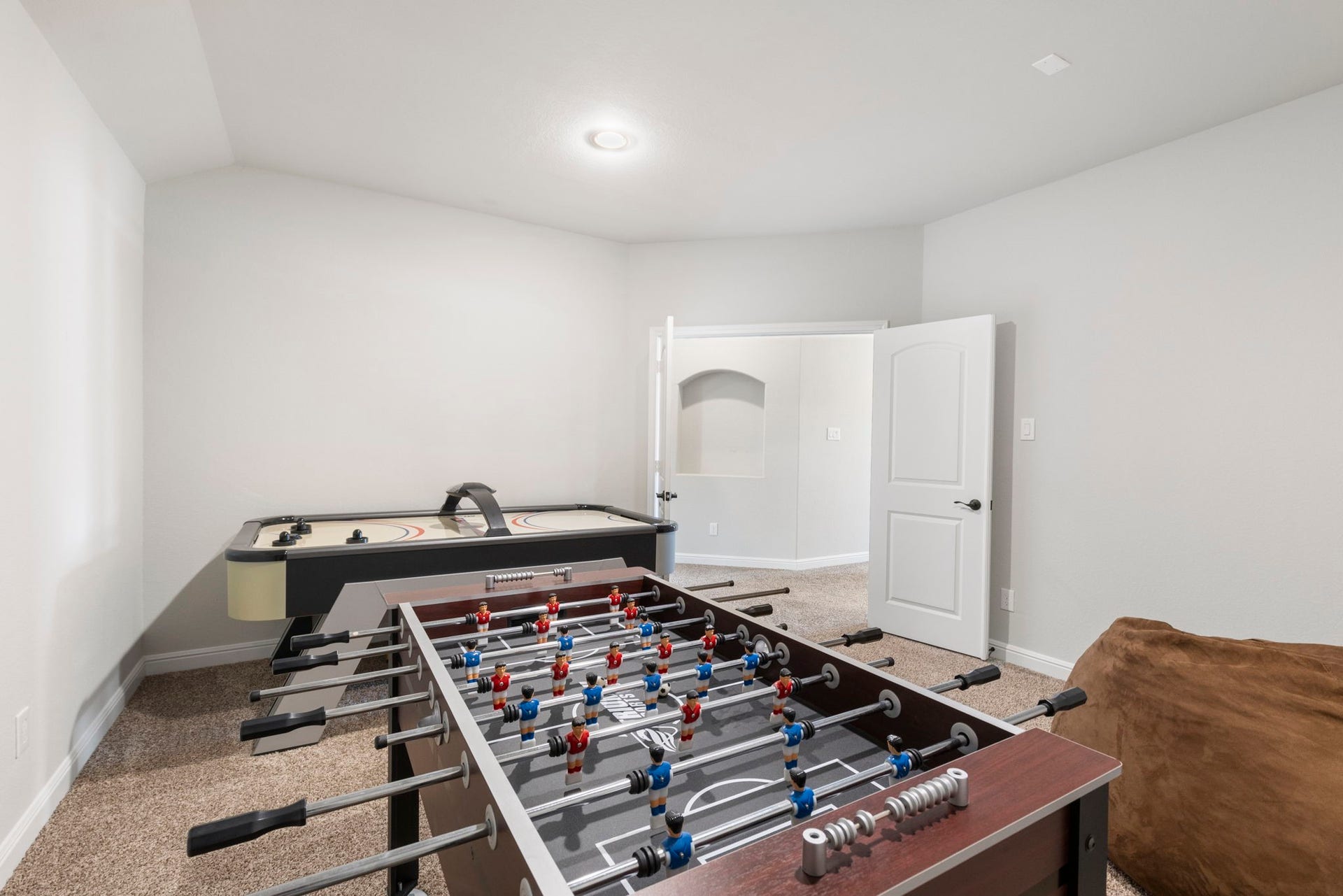 2819 Bradbury Hills Drive, Spring, TX 77373 Experience ultimate entertainment in this inviting media room, complete with foosball and air hockey tables for endless fun.