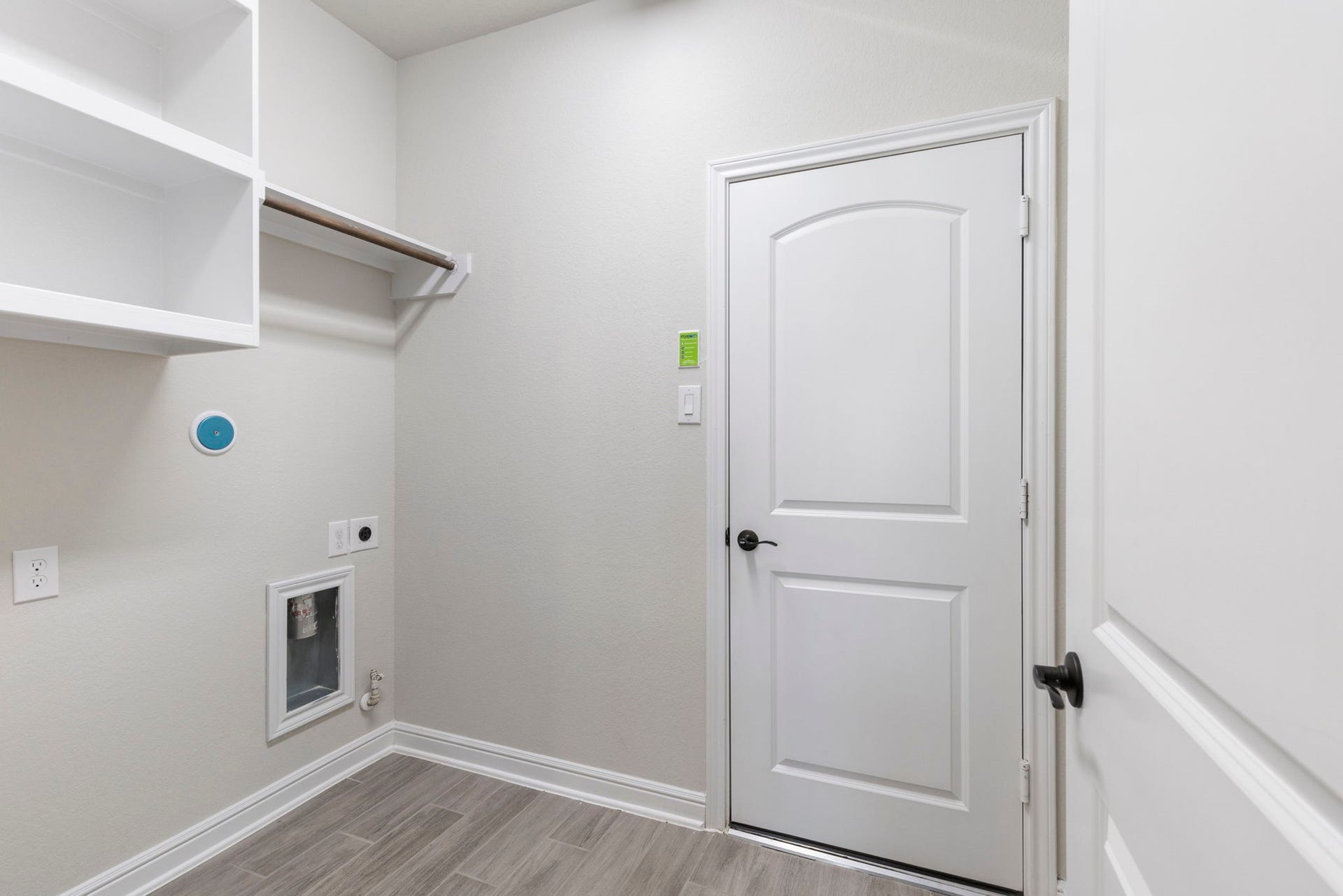 2819 Bradbury Hills Drive, Spring, TX 77373 This sleek utility/laundry room offers ample storage and organization space, featuring modern shelving and fresh, clean design for efficient functionality.