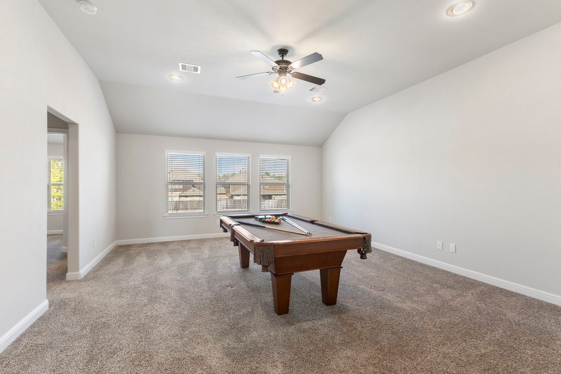 2819 Bradbury Hills Drive, Spring, TX 77373 Discover endless fun in this spacious game room, featuring a stylish pool table, plush carpeting, and ample natural lightperfect for entertaining or relaxing.