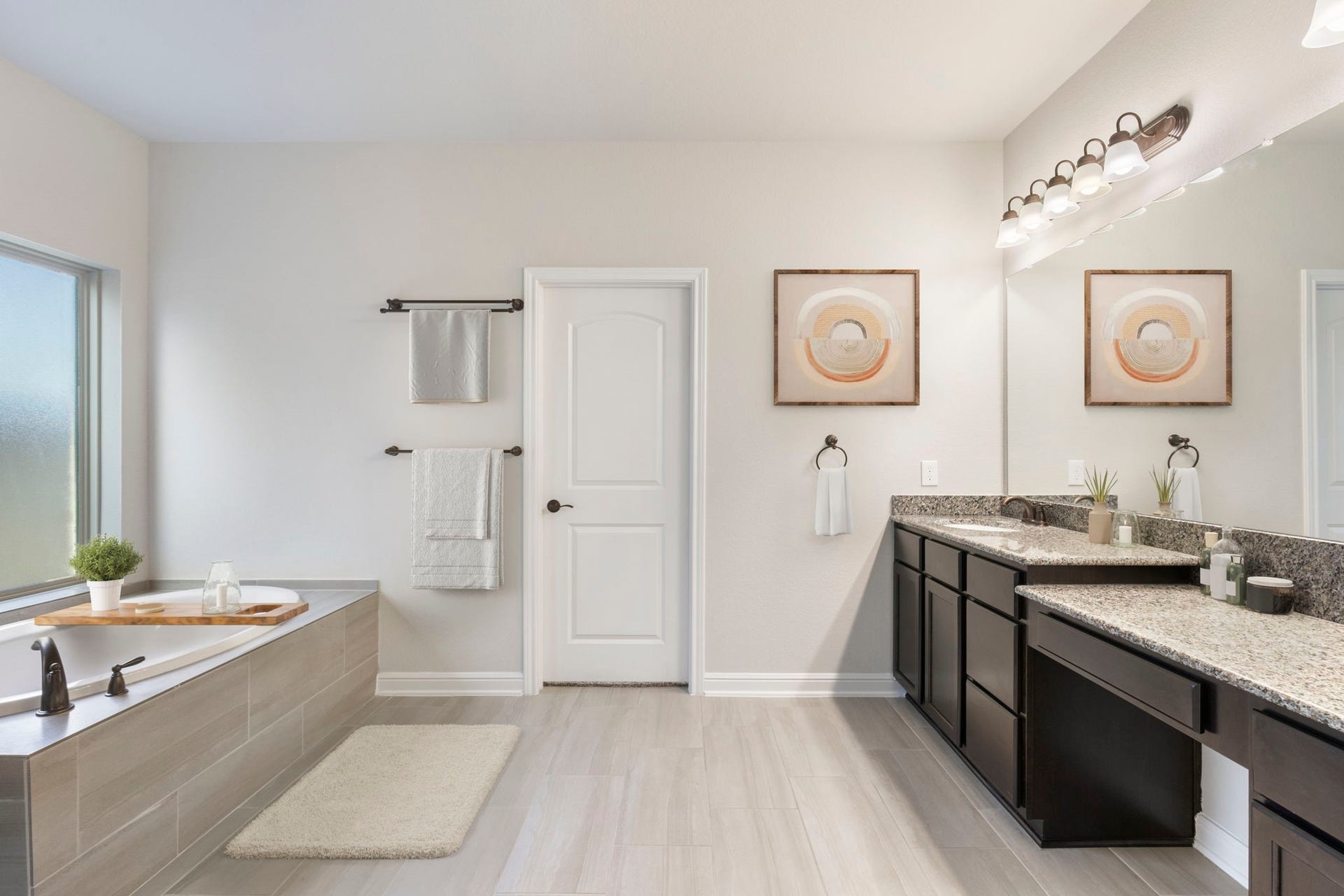 2819 Bradbury Hills Drive, Spring, TX 77373 Experience the elegance of a virtually staged bathroom, featuring a sleek double vanity, luxurious soaking tub, and modern accents, perfect for relaxing in style.