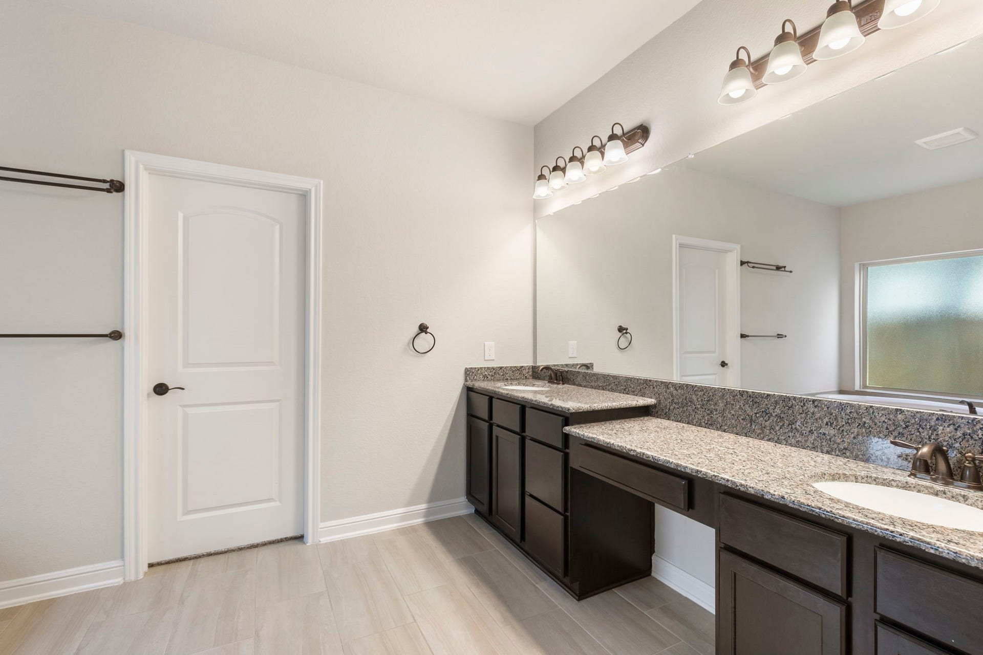 2819 Bradbury Hills Drive, Spring, TX 77373 Experience luxury in this primary bathroom featuring elegant granite countertops, dual sinks, and stylish modern lighting, creating a serene and sophisticated retreat.