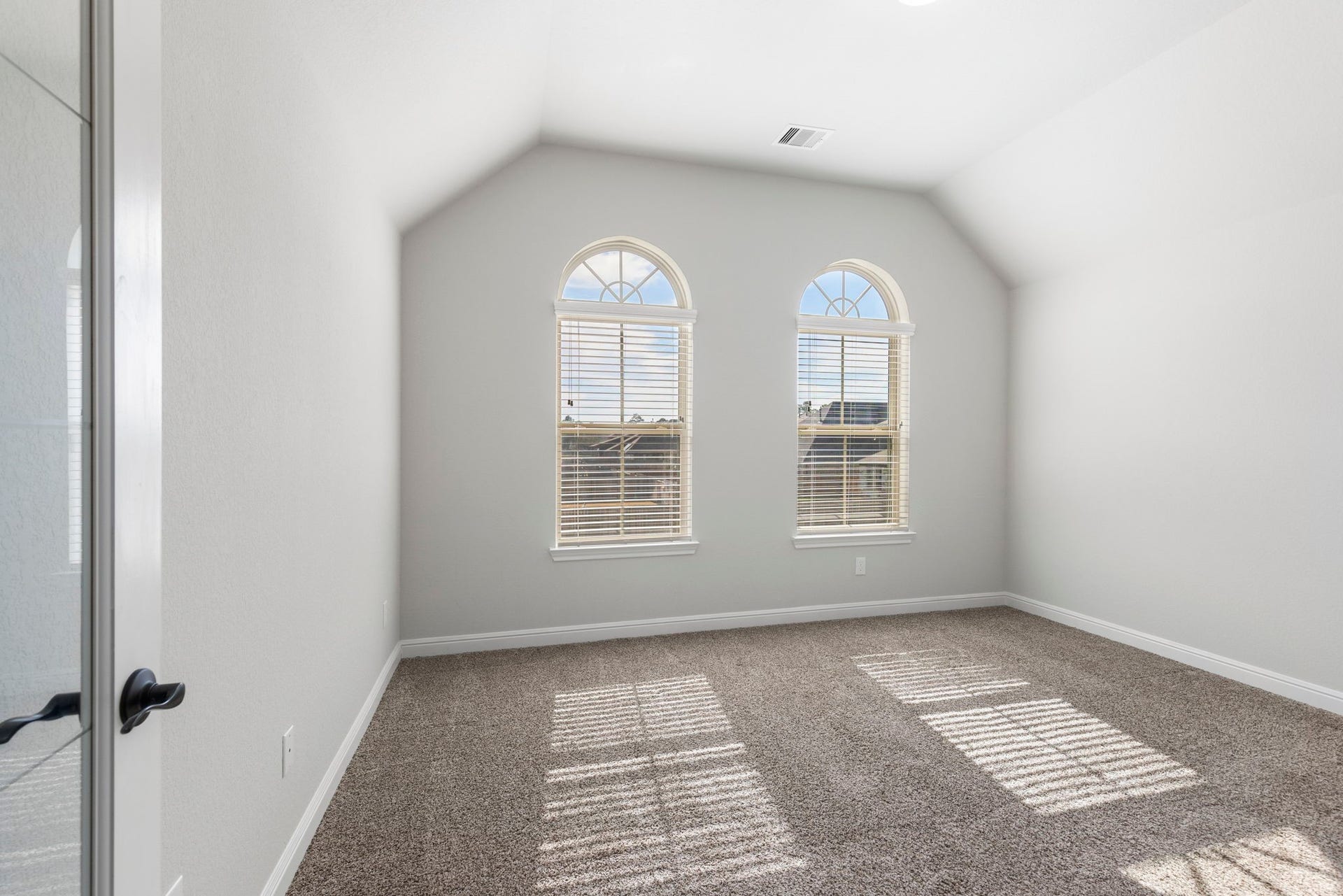 2819 Bradbury Hills Drive, Spring, TX 77373 This inviting study/office features elegant arched windows that flood the space with natural light, creating the perfect environment for focused work or peaceful reflection.
