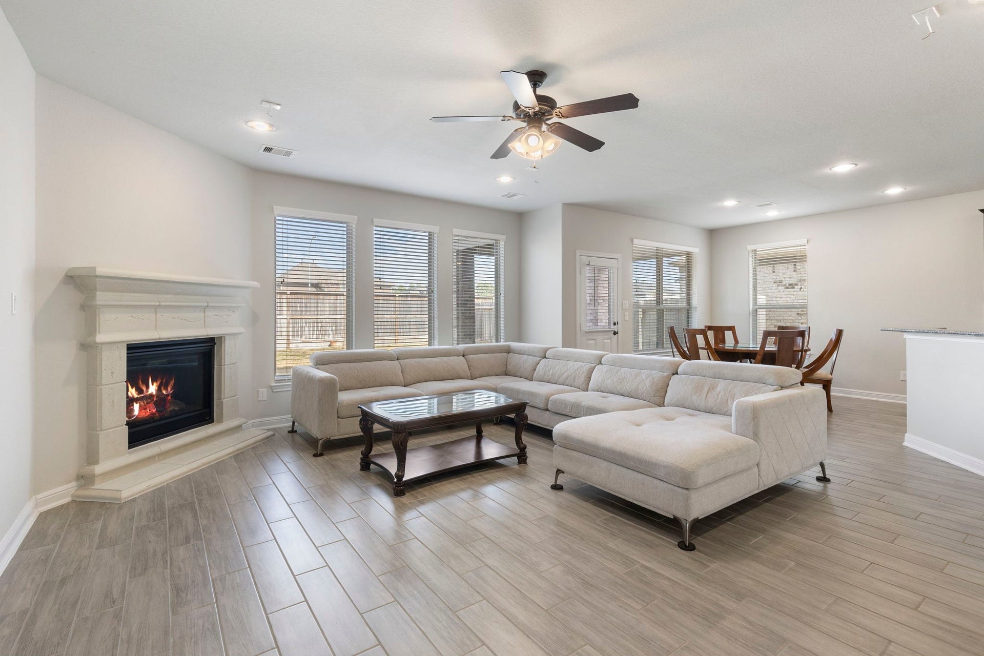 2819 Bradbury Hills Drive, Spring, TX 77373 This inviting family room features a cozy fireplace, abundant natural light from expansive windows, and an open layout perfect for gatherings and relaxation.