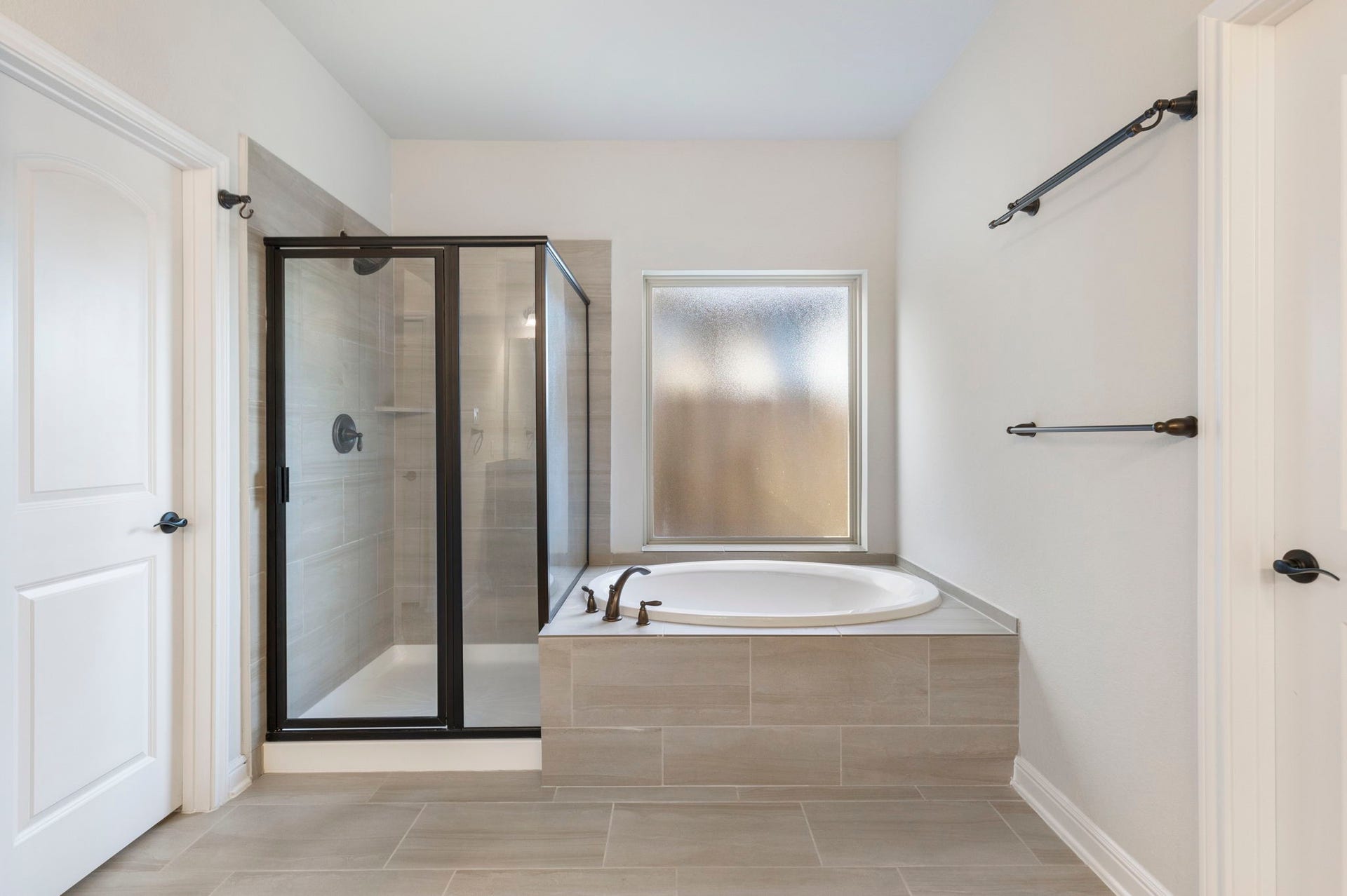 2819 Bradbury Hills Drive, Spring, TX 77373 Discover serenity in this primary bathroom, featuring a sleek glass-enclosed shower and a luxurious soaking tub, all bathed in soft, natural light.