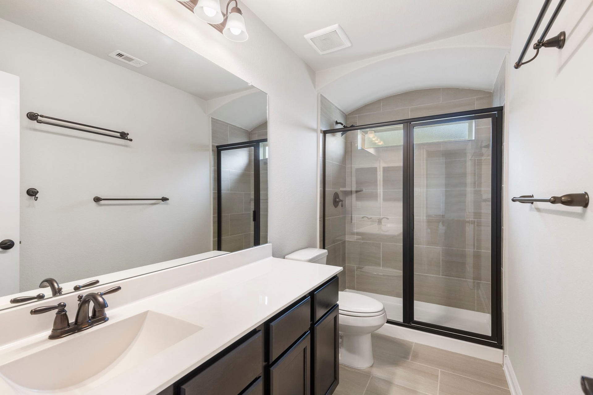 2819 Bradbury Hills Drive, Spring, TX 77373 Discover modern elegance in Bathroom 2, featuring a sleek glass-enclosed shower, stylish fixtures, and ample counter space for a luxurious yet functional retreat.