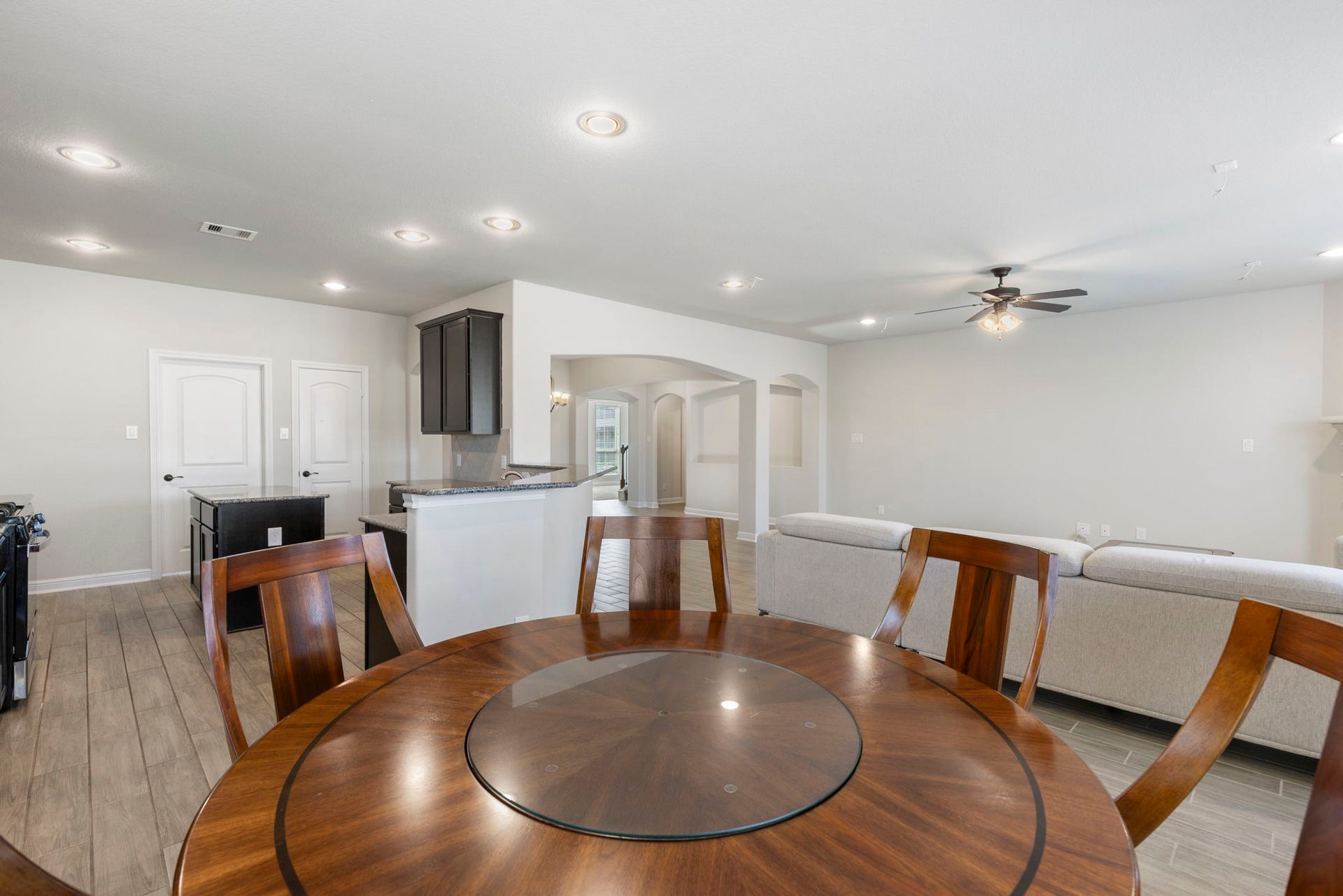 2819 Bradbury Hills Drive, Spring, TX 77373 This inviting breakfast area seamlessly blends with the open living space, featuring elegant wood flooring and abundant natural light, perfect for morning gatherings and cozy family meals.