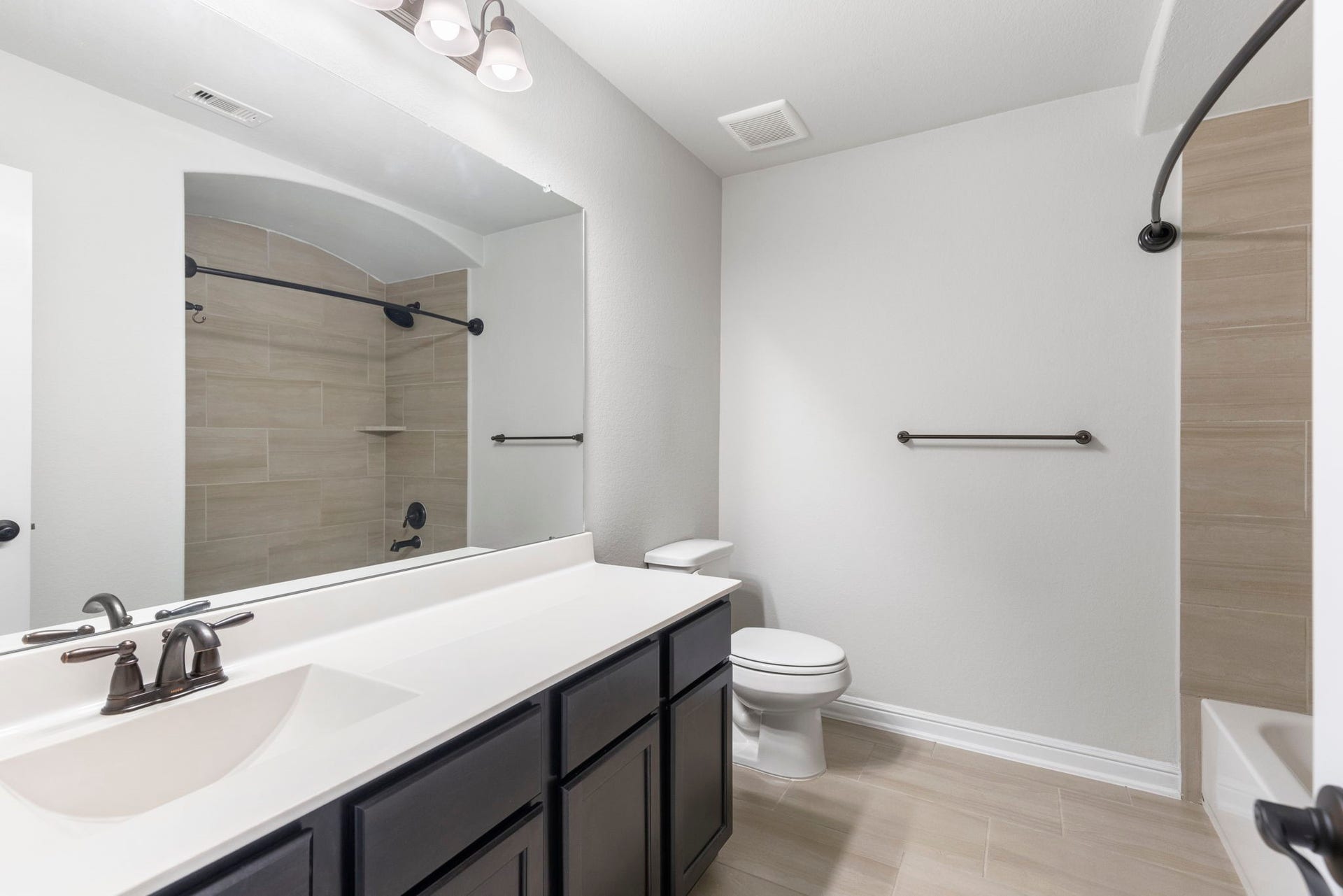 2819 Bradbury Hills Drive, Spring, TX 77373 Discover a sleek and modern bathroom featuring elegant fixtures, ample vanity space, and a stylish tiled shower, perfect for a refreshing start to your day.