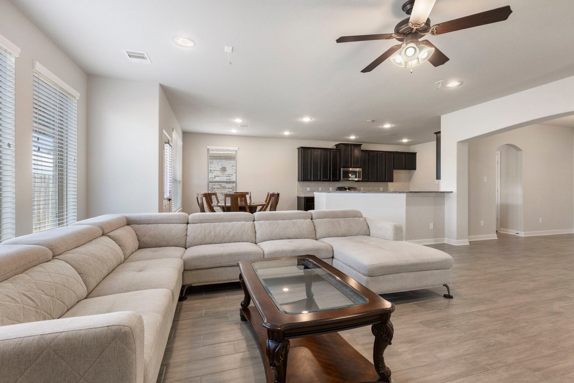 2819 Bradbury Hills Drive, Spring, TX 77373 Experience comfort and style in this bright, open-concept family room featuring a spacious sectional, elegant hardwood floors, and seamless flow into the modern kitchen.
