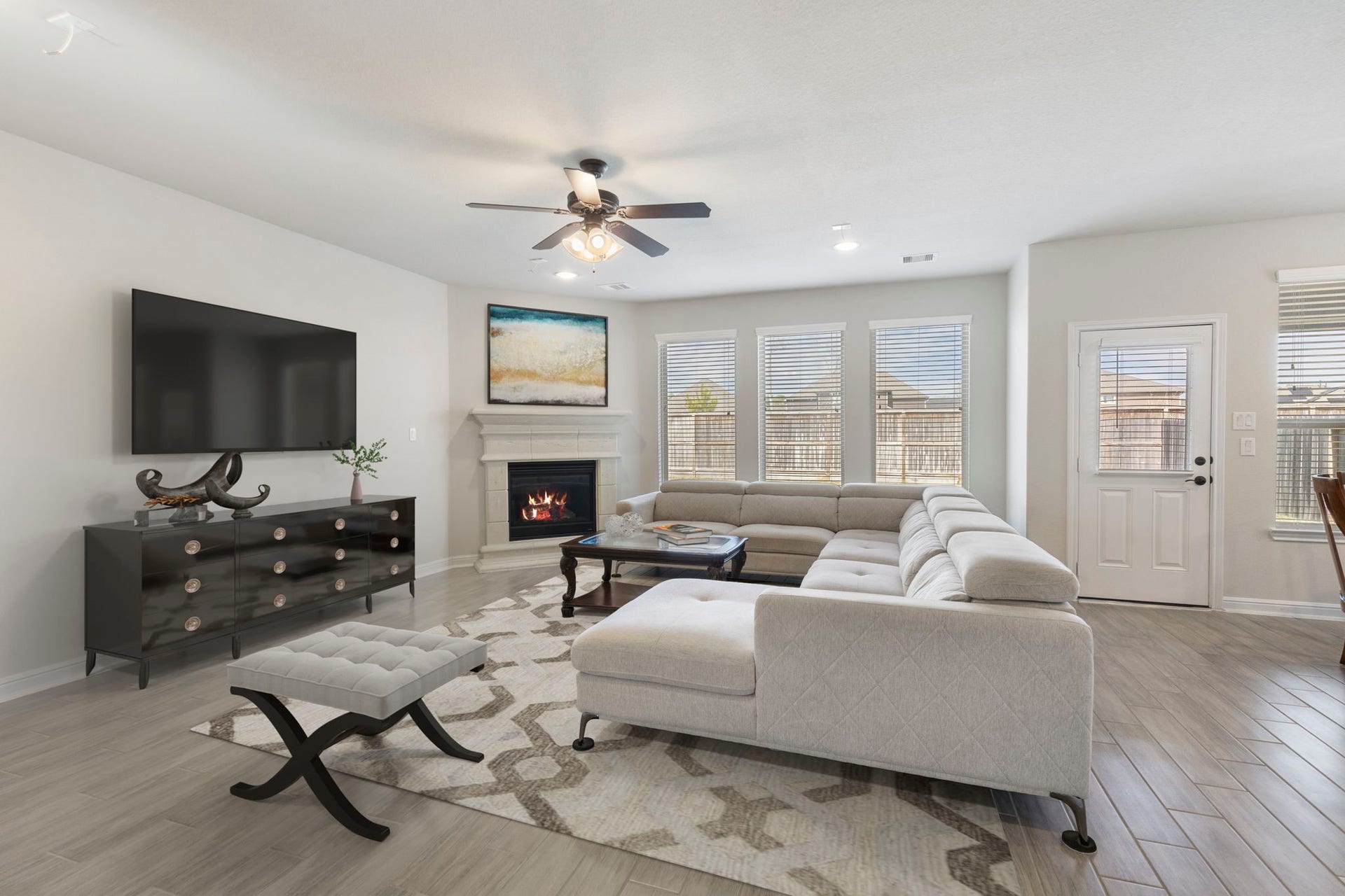 2819 Bradbury Hills Drive, Spring, TX 77373 Experience modern elegance in this virtually staged living room, featuring a cozy fireplace, abundant natural light, and sleek design elements perfect for stylish gatherings.