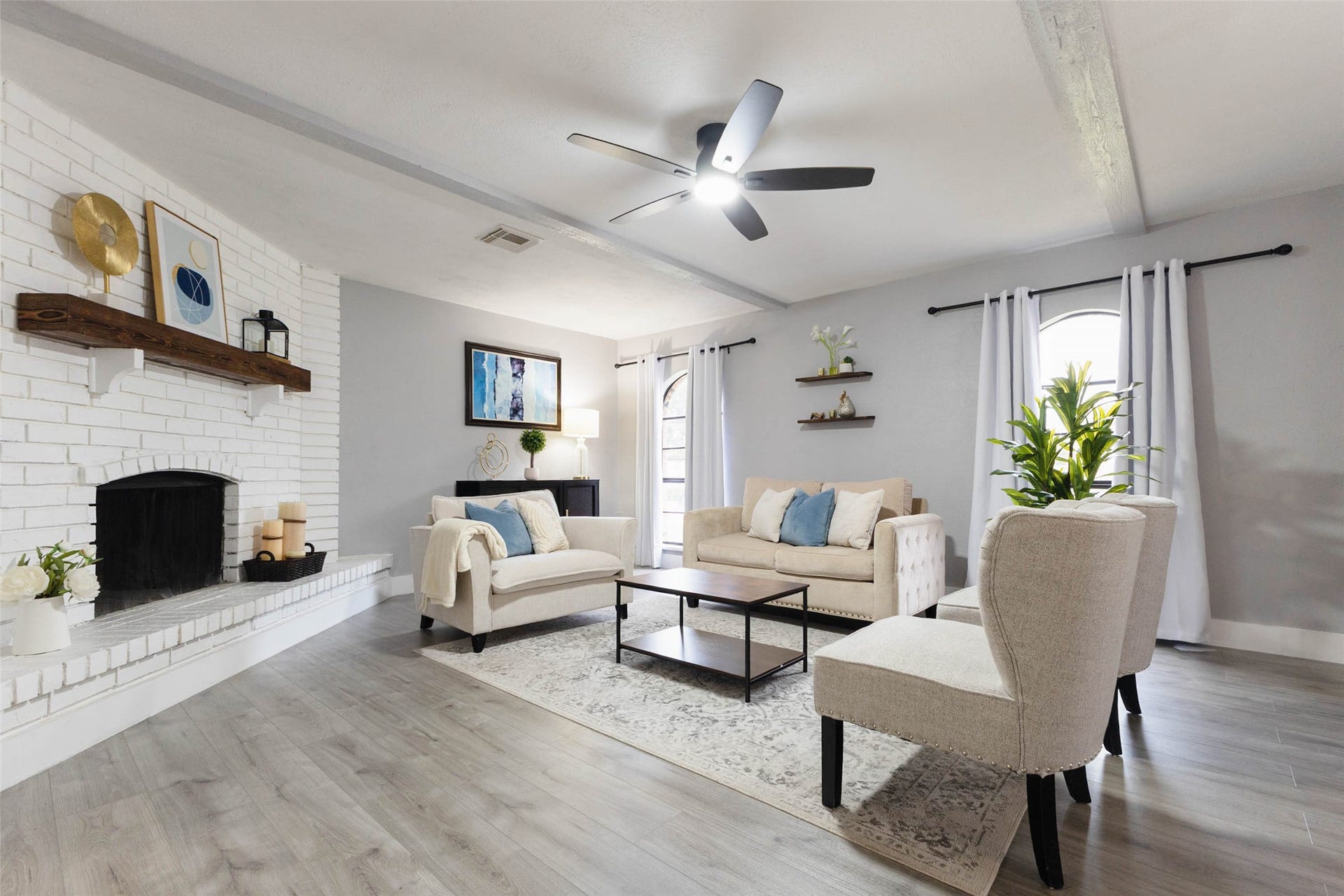 17302 S Yorkglen Drive, Houston, TX 77084 Bright, open living room with a painted brick fireplace and wood mantle plenty of space to gather.