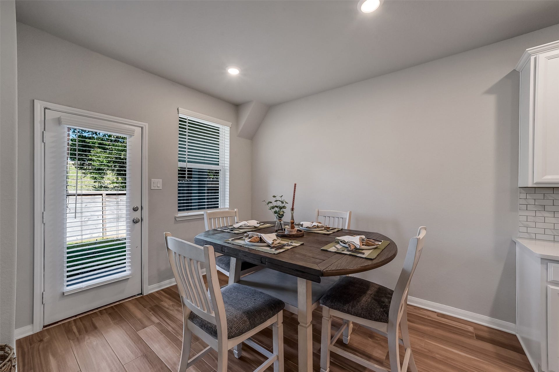 Start your morning in this inviting breakfast area just off the kitchen, with natural light from the window and a glass-paneled door leading to the covered patio.window and glass-paneled exterior door, with the dining area conveniently located just off the kitchen.