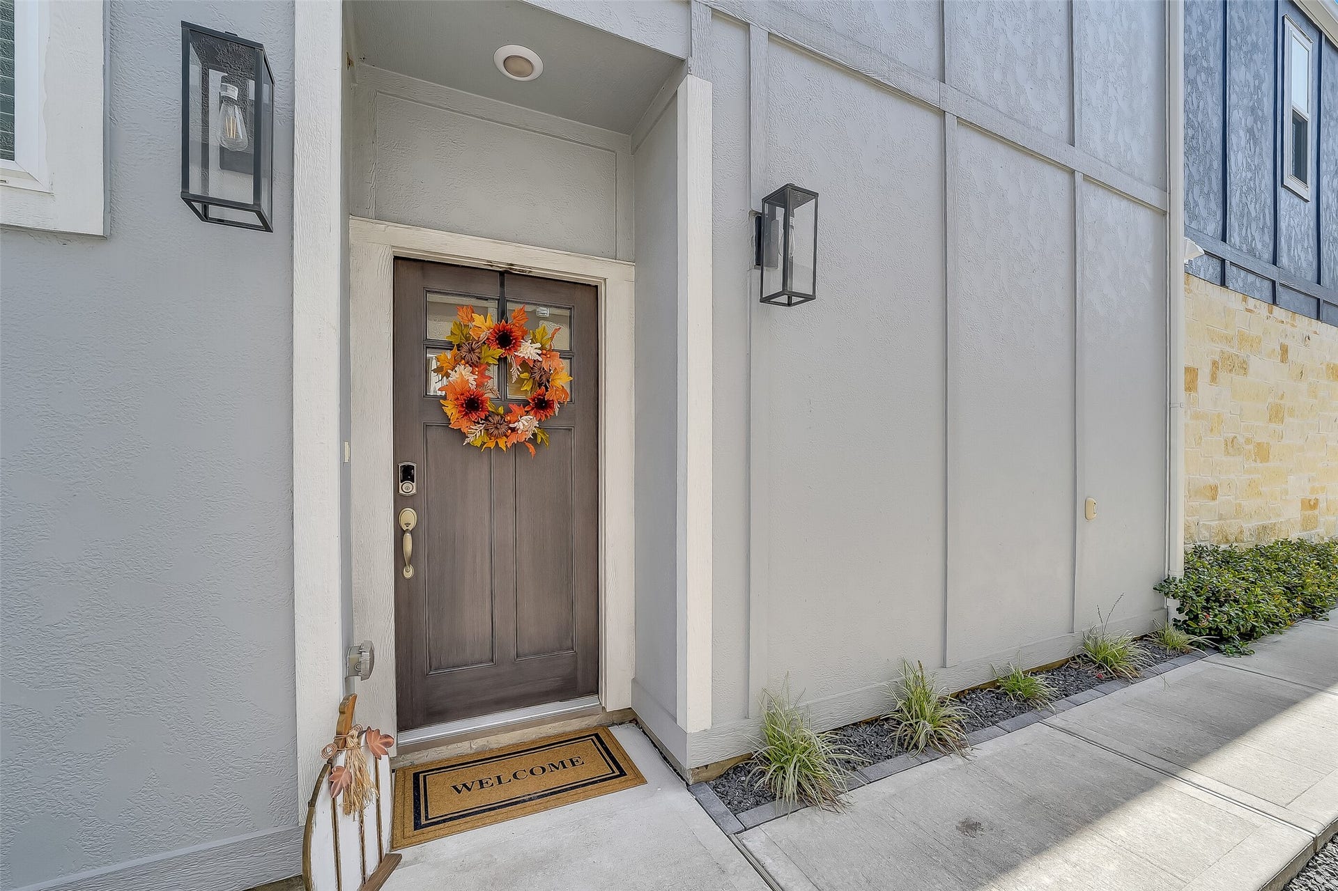 A sheltered front entry offers a welcoming spot to greet guests, with a windowed front door that brings light inside.