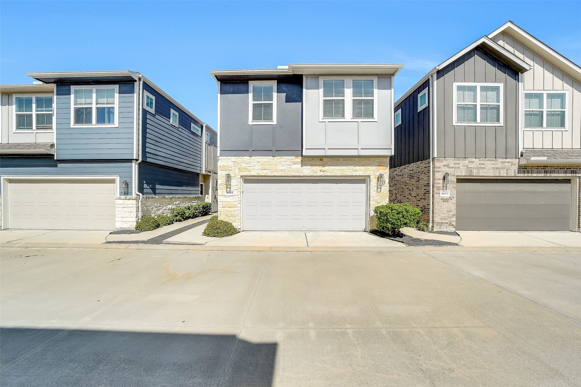 Stone accents and contemporary lines create a welcoming first impression, with a two-car garage conveniently positioned at the front of the home.