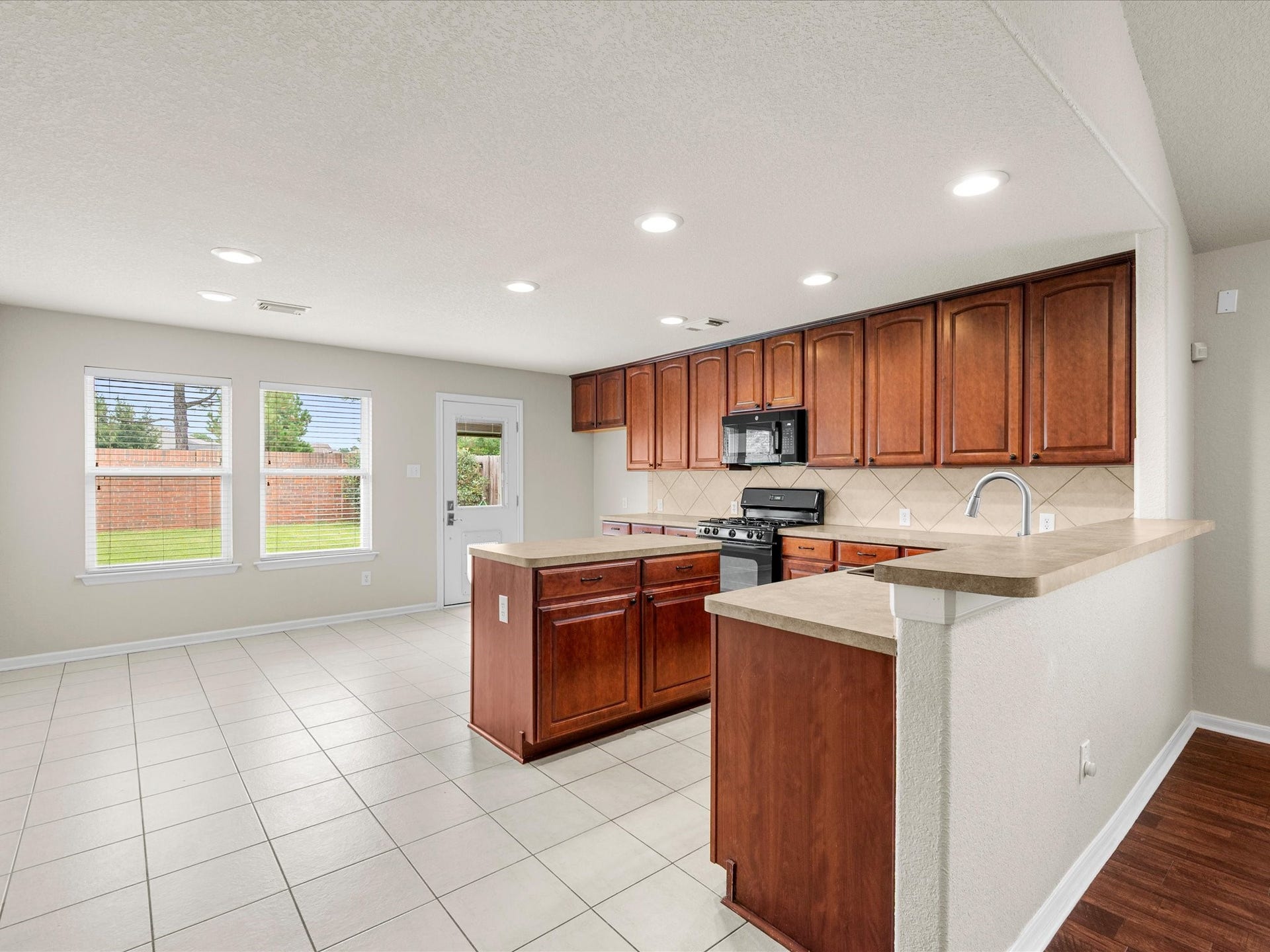20118 Monarda Manor Court, Spring, TX 77379 A generous kitchen island provides additional workspace and casual seating, while abundant cabinetry offers excellent storage and functionality.