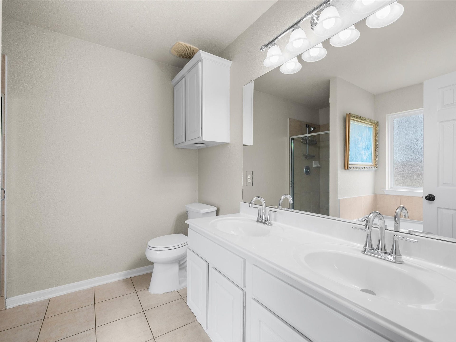 20118 Monarda Manor Court, Spring, TX 77379 The private ensuite features a soaking tub, separate shower, updated sinks, and a spacious walk-in closet for added comfort and convenience.