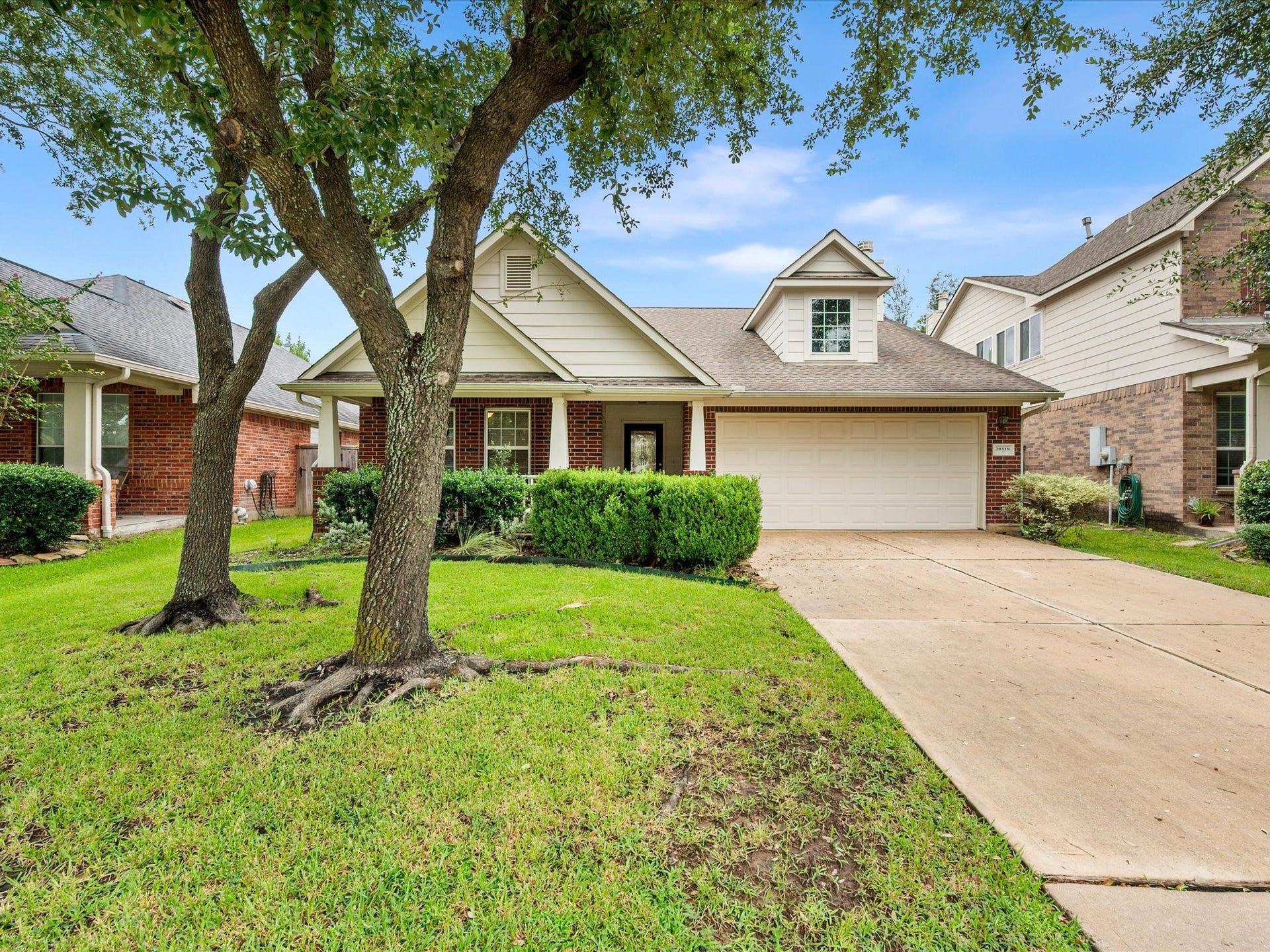 20118 Monarda Manor Court, Spring, TX 77379 A beautifully maintained exterior welcomes you home with mature trees, a well-kept lawn, and the timeless appeal of the Gleannloch Farms community.