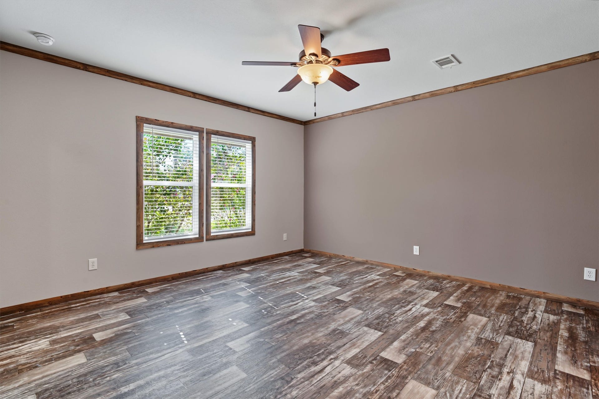 546 5th Street, Dickinson, TX 77539 Oversized Primary Retreat A spacious primary bedroom filled with natural light and enhanced by custom accent paint, creating a warm and inviting retreat to relax and unwind