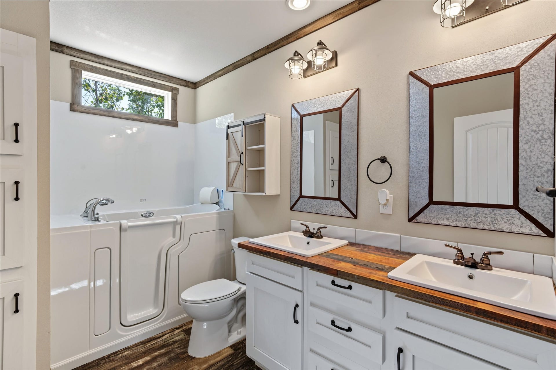 546 5th Street, Dickinson, TX 77539 Spacious Guest Bathroom Featuring a double-sink vanity and a handicap-accessible tub, this well-appointed bathroom offers comfort, convenience, and functionality