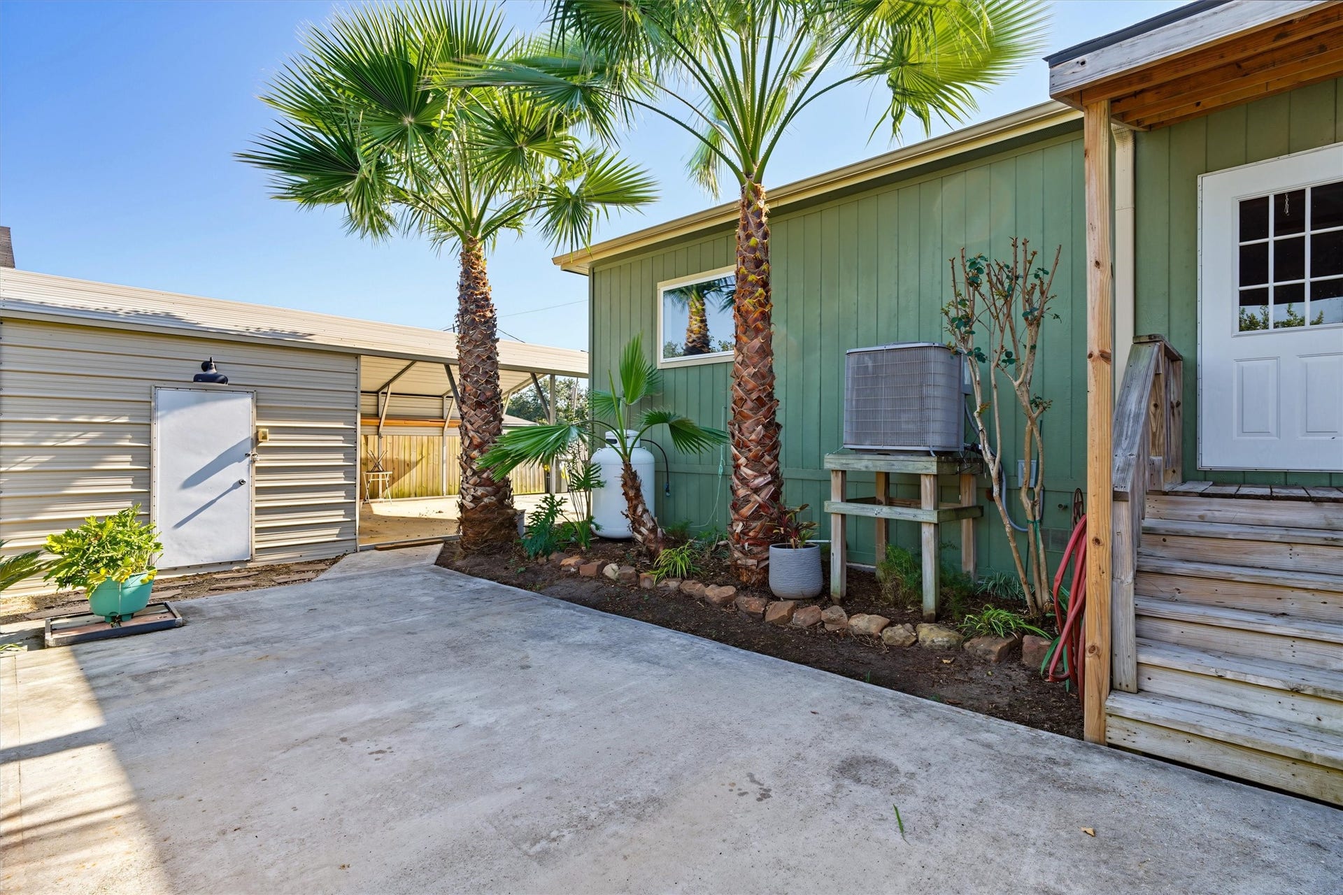 546 5th Street, Dickinson, TX 77539 View of backyard patio, back door entering into the utility room, and the garage