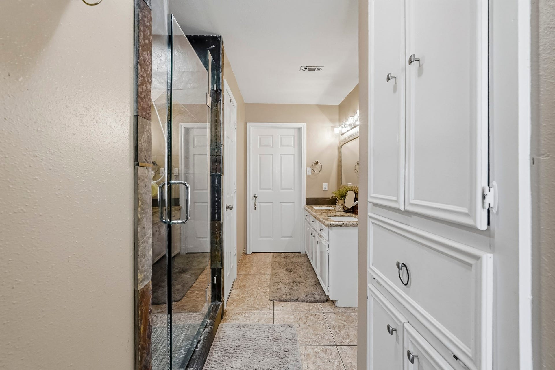 1207 9th Street, Galena Park, TX 77547 Primary bathroom featuring a spacious glass-enclosed shower, stylish countertop, and ample cabinet storage for a refined touch.