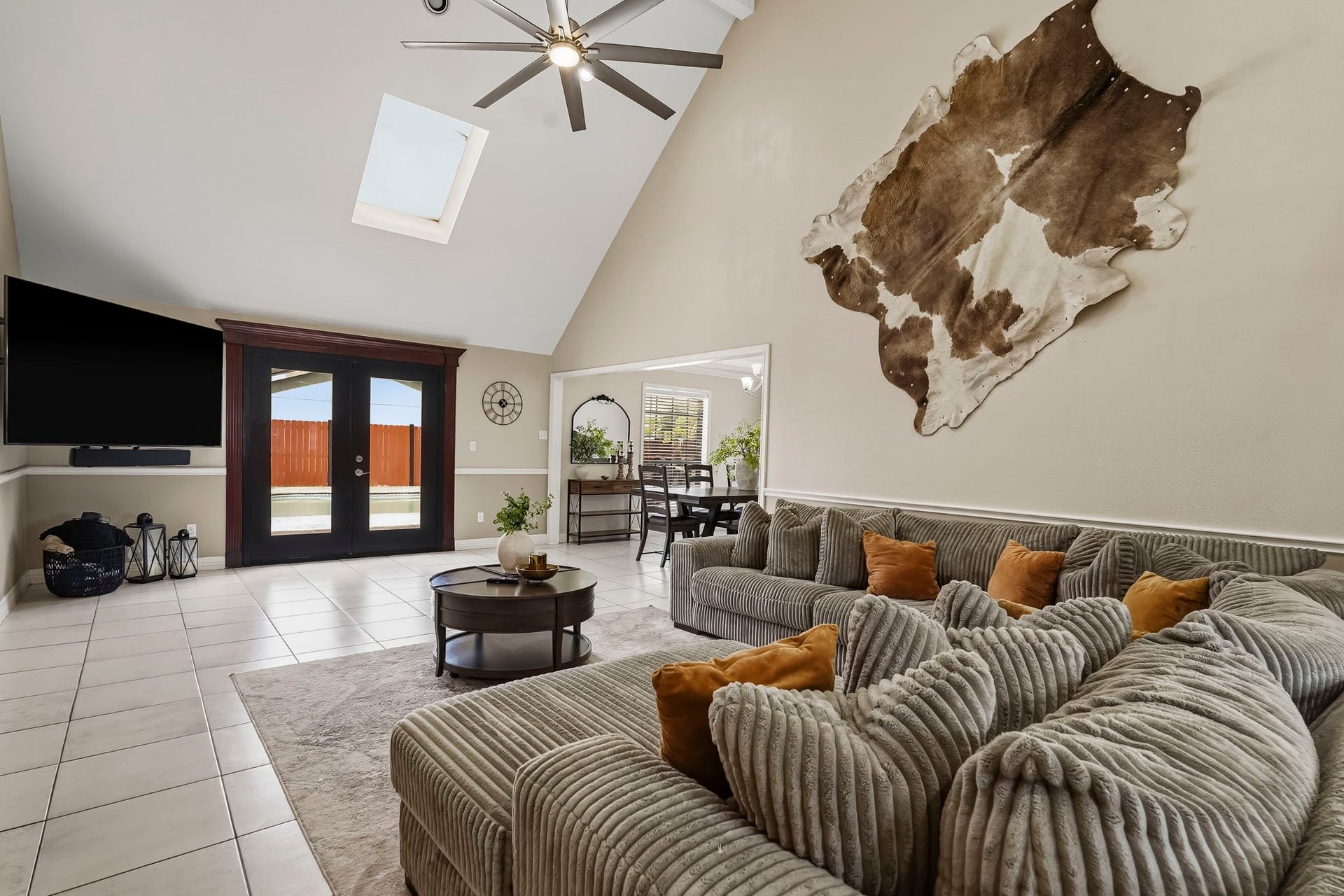 1207 9th Street, Galena Park, TX 77547 Spacious living room with high ceilings and a skylight. French doors open to the backyard, offering ample natural light and seamless indoor-outdoor living.