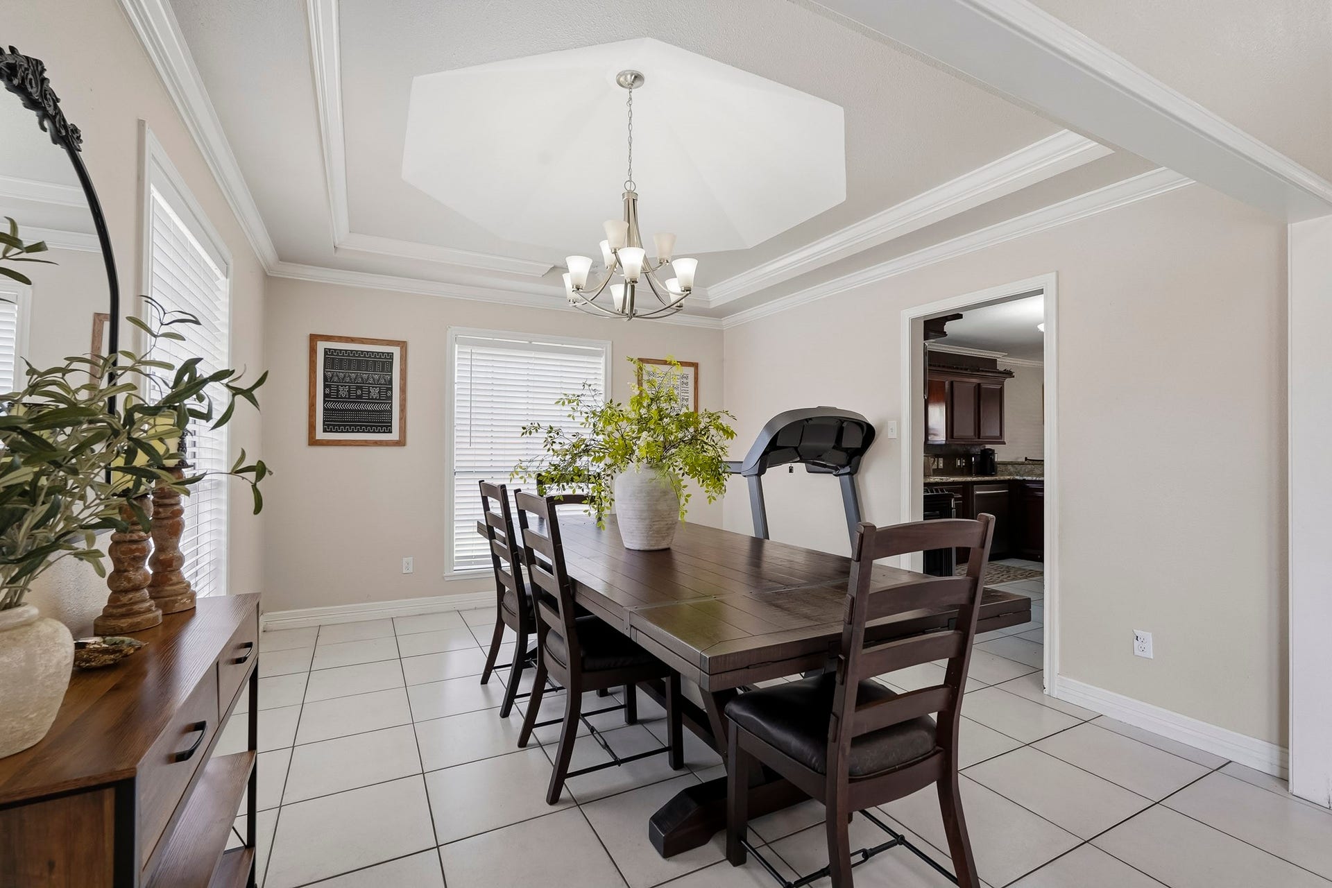 1207 9th Street, Galena Park, TX 77547 Elegant dining room featuring a spacious table, modern chandelier, and abundant natural light from large windows, perfect for gatherings.