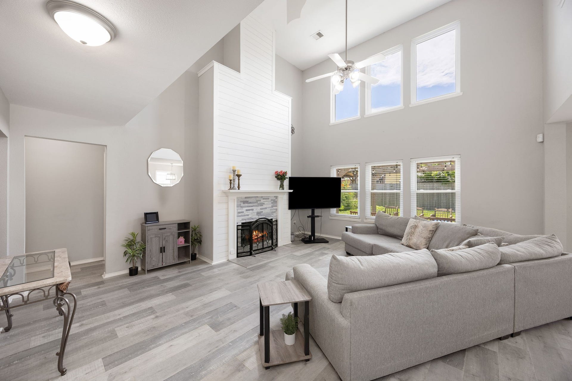 3915 Eastland Lake Drive, Richmond, TX 77406 Centered in the main living space, the family room features an impressive high ceiling, engineered wood flooring, and a floor-to-ceiling accent fireplace surround.