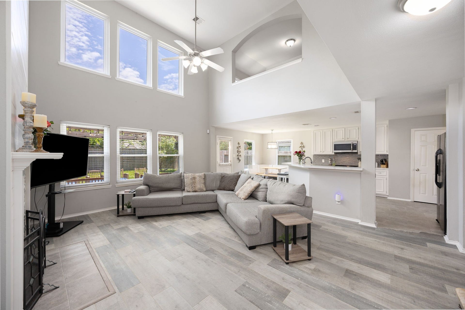 3915 Eastland Lake Drive, Richmond, TX 77406 Looking from the corner of the room, the open-concept layout reveals how the expansive living room transitions directly into the kitchen area.