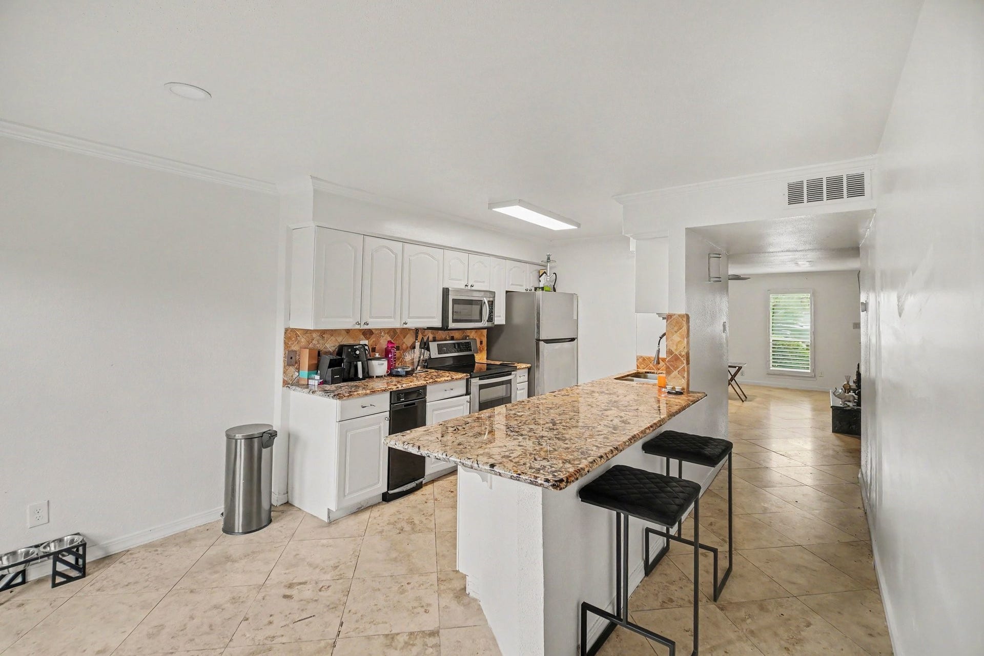 Experience culinary elegance in a kitchen featuring sleek granite counters, perfect for entertaining and everyday living.